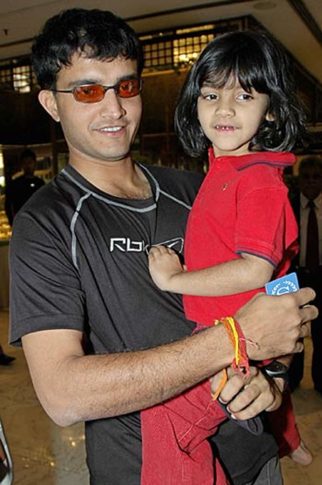 Sourav Ganguly holds his daughter Sana as he leaves The Arabian Sea Country Club in Karachi, January 27, 2006