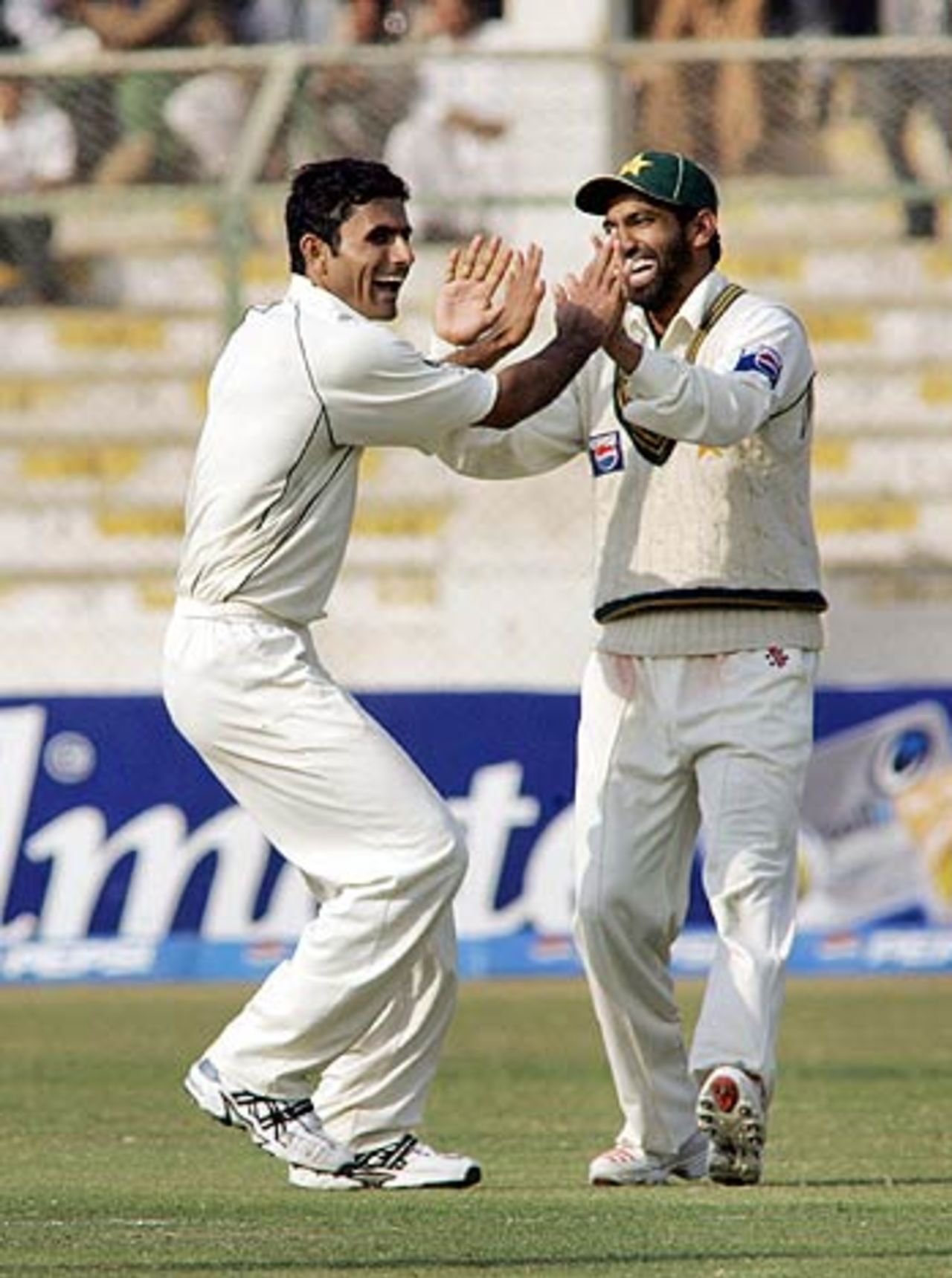 Abdul Razzaq and Mohammad Yousuf celebrate the fall of Mahendra Singh Dhoni, Pakistan v India, 3rd Test, 4th day, Karachi, February 1,2006