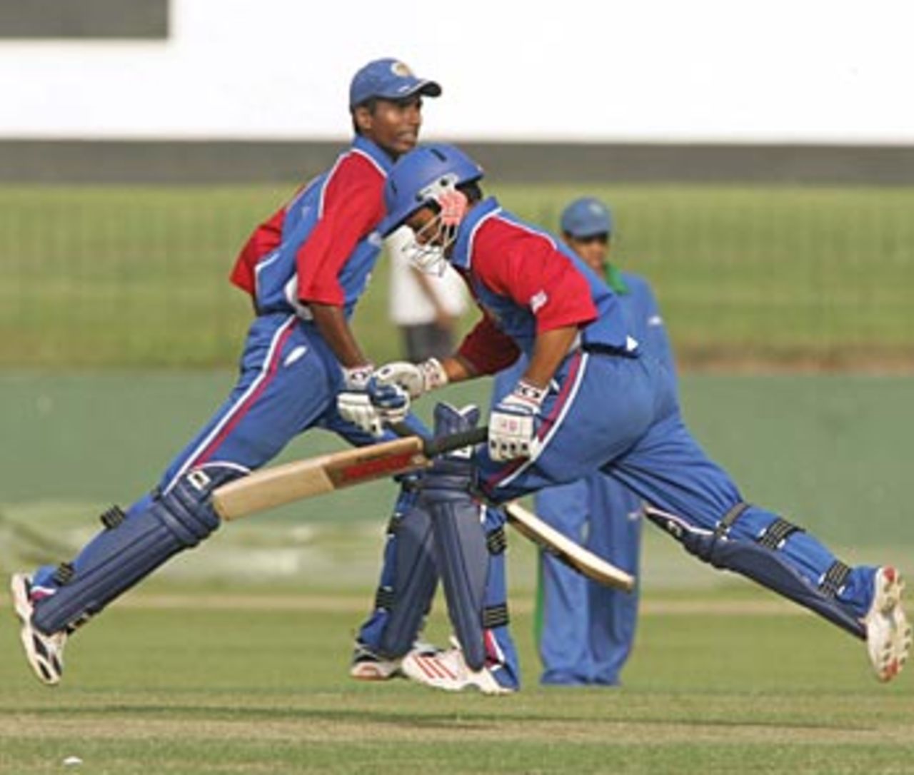 Mrunal Patel (left) and Nisarg Patel (right) complete another run during the USAs successful run-chase against Namibia in the Plate Championship QF match in the ICC U/19 Cricket World Cup in Colombo, Sri Lanka on Tuesday.  The USA won the match by two wickets, their first-ever win in the tournament. February 14, 2005