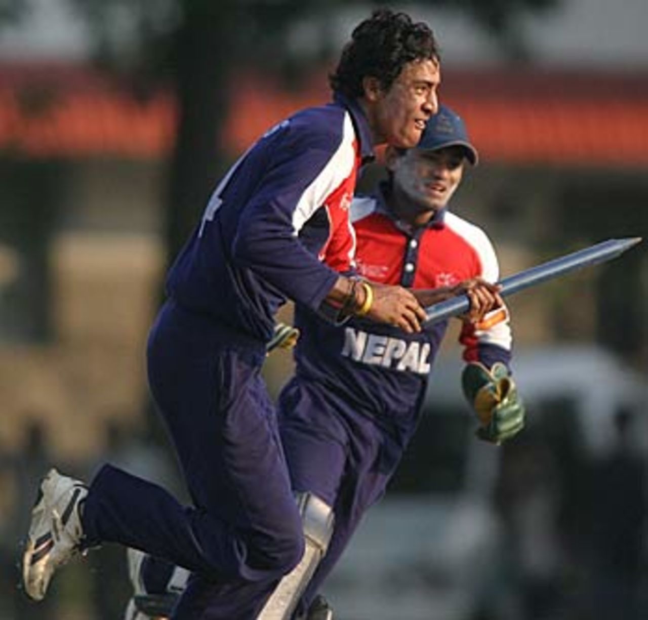 Paras Khadka and Mahesh Chhetri sprint from the field complete with souvenir stump, Nepal v South Africa, Under-19 World Cup, February 16, 2006
