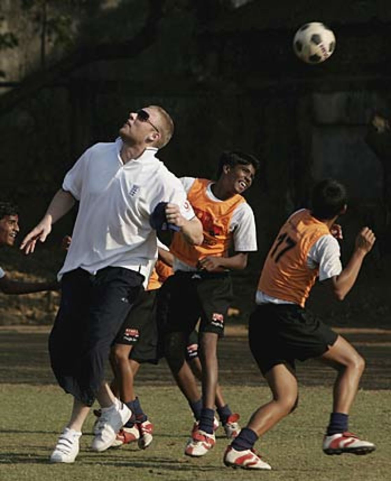Andrew Flintoff plays football with orphans during a visit to the Magic Bus Child development program in Lower Parel, Mumbai, February 17, 2006