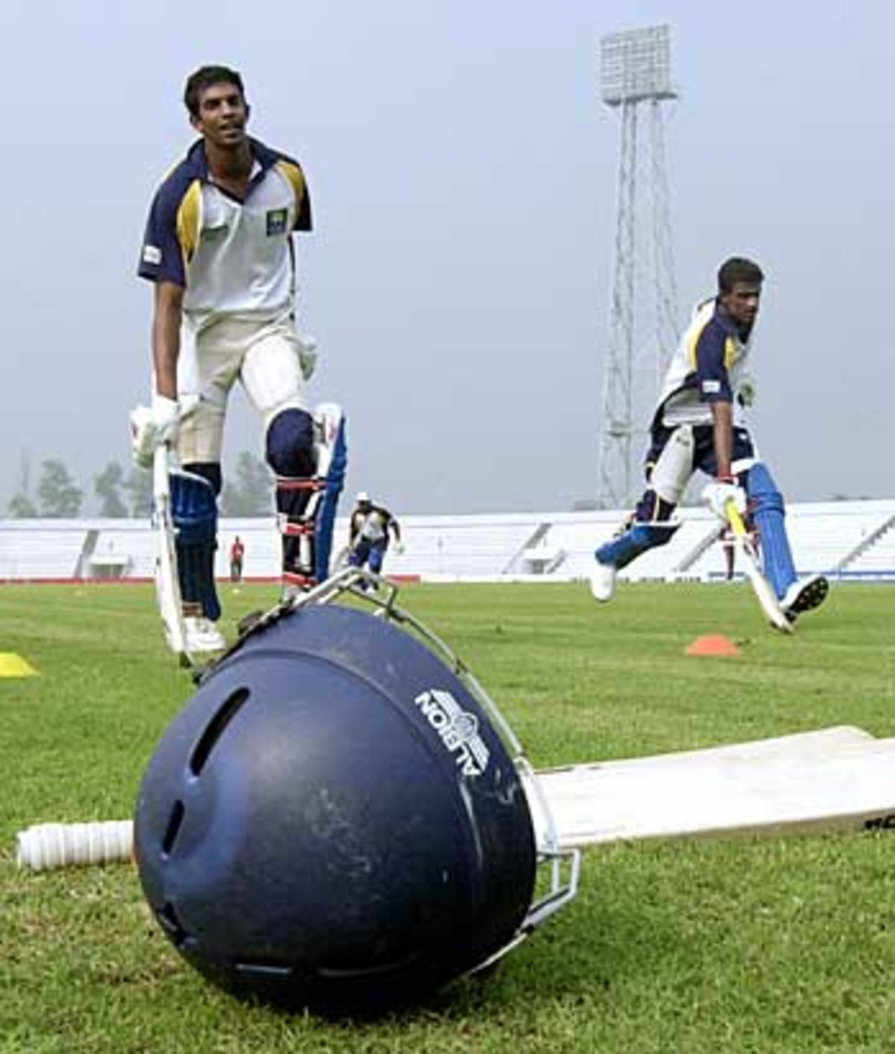 Sri Lanka's cricketers go through their paces and practice their running between the wicket during a net session, Bogra, February 19, 2006