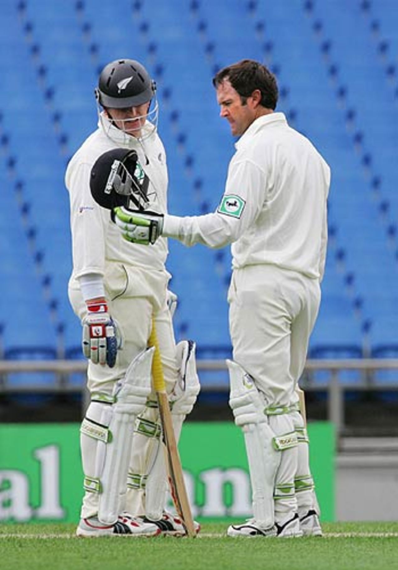 Scott Styris examines Nathan Astle's helmet after he got hit by a bouncer, New Zealand v West Indies, 1st Test, Auckland, 1st day, March 9, 2006
