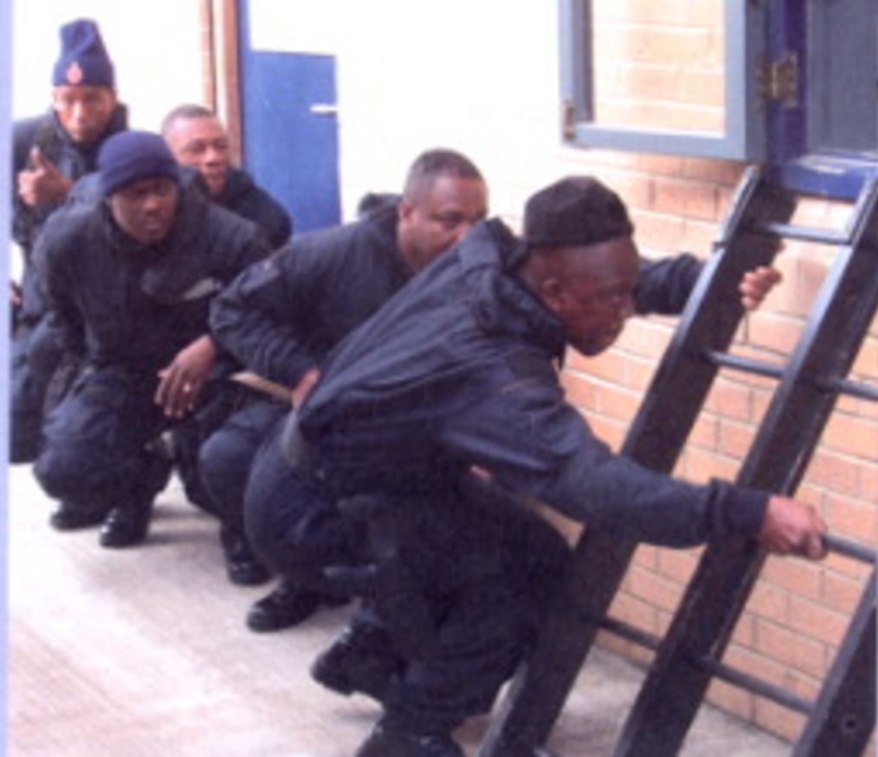 The Royal Barbados Police Force gets ready to storm a building during a four-week exercise to prepare for the World Cup, March 9, 2006