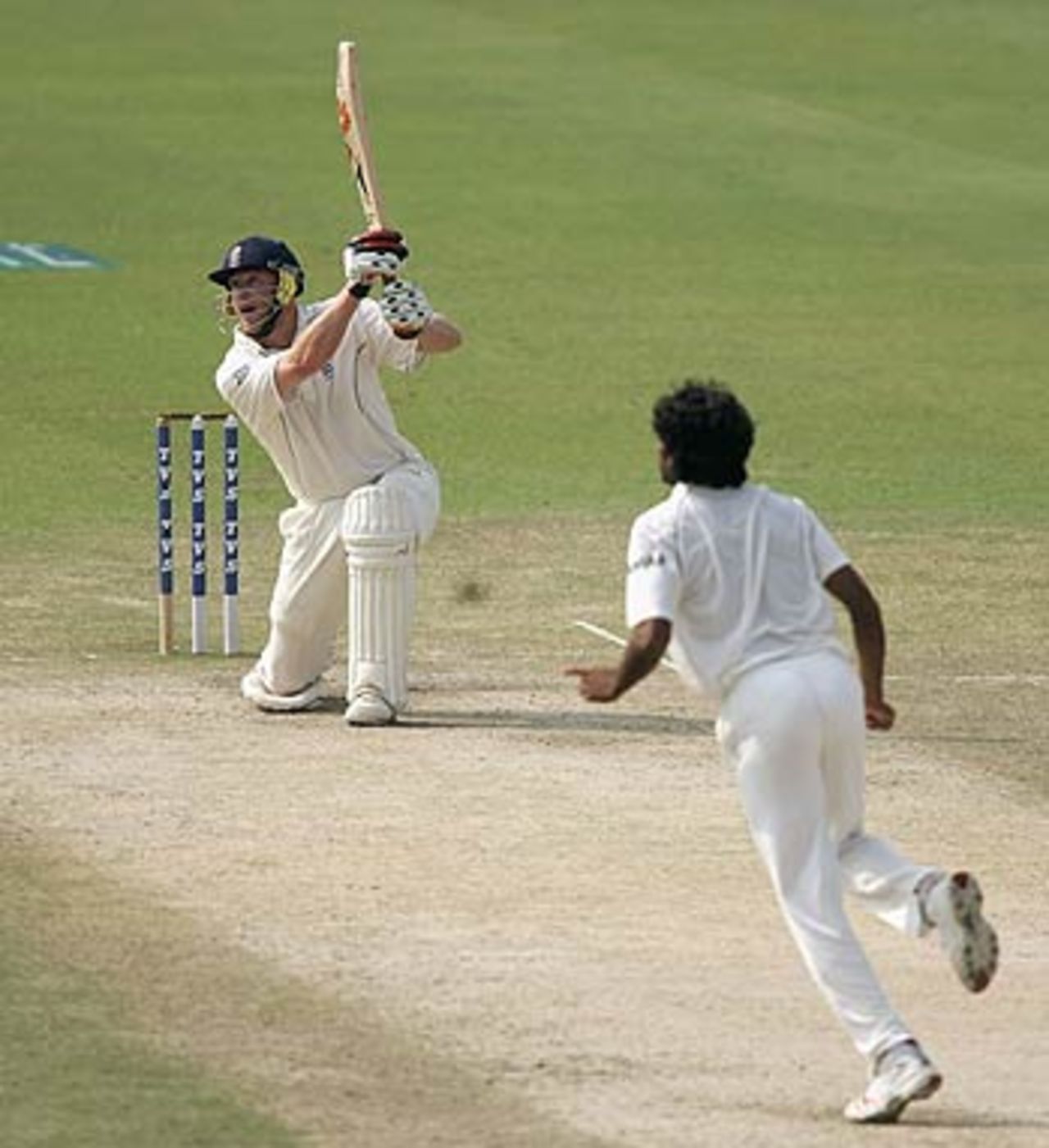Andrew Flintoff gets down on his knee and carts Munaf Patel over the off side, India v England, 2nd Test, Mohali, 5th day, March 13 2006