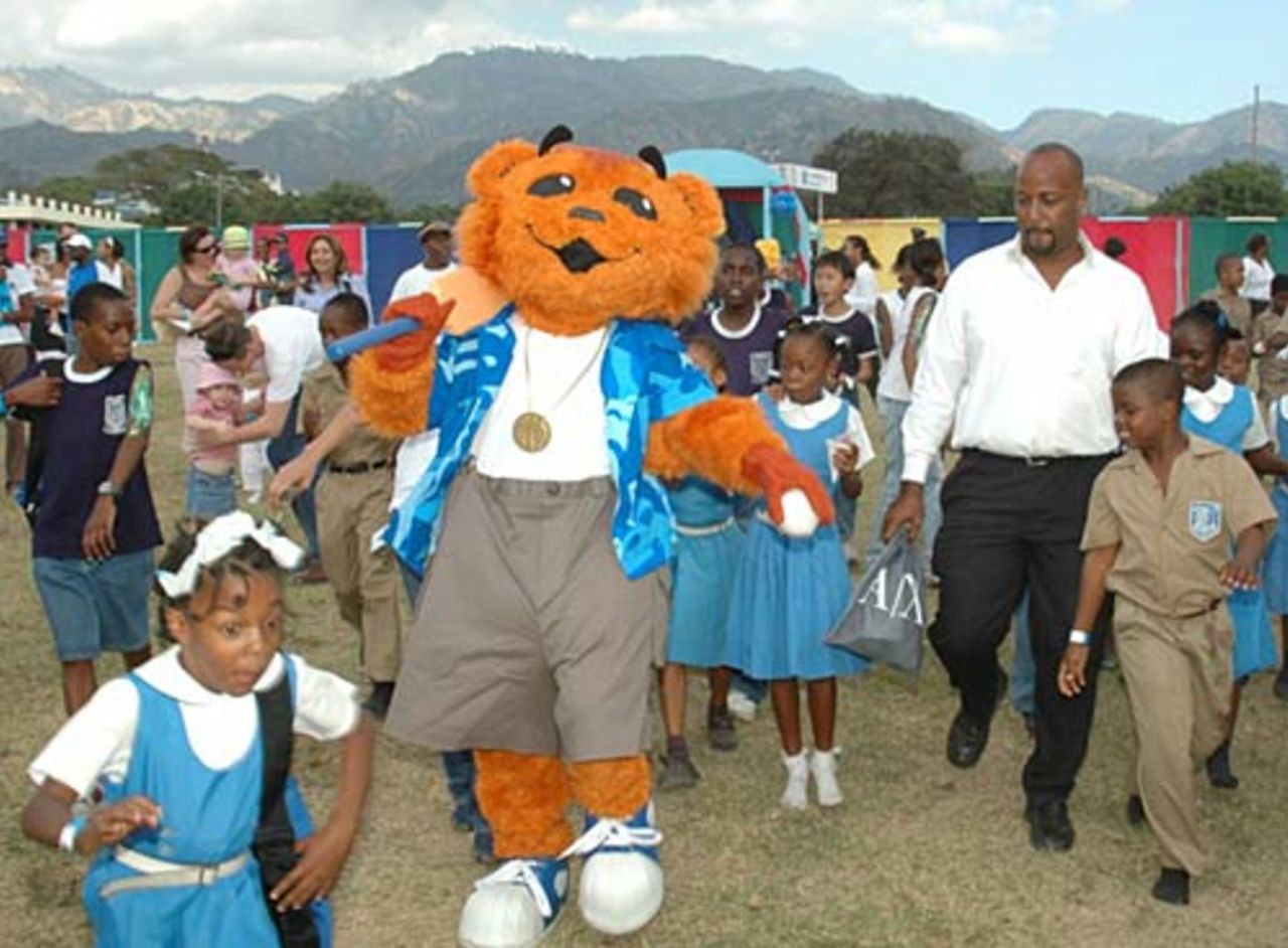 Mello, the World Cup mascot, arrives at Jamaica College as scores of schoolchildren run to get a glimpse and touch of him, March 13, 2006