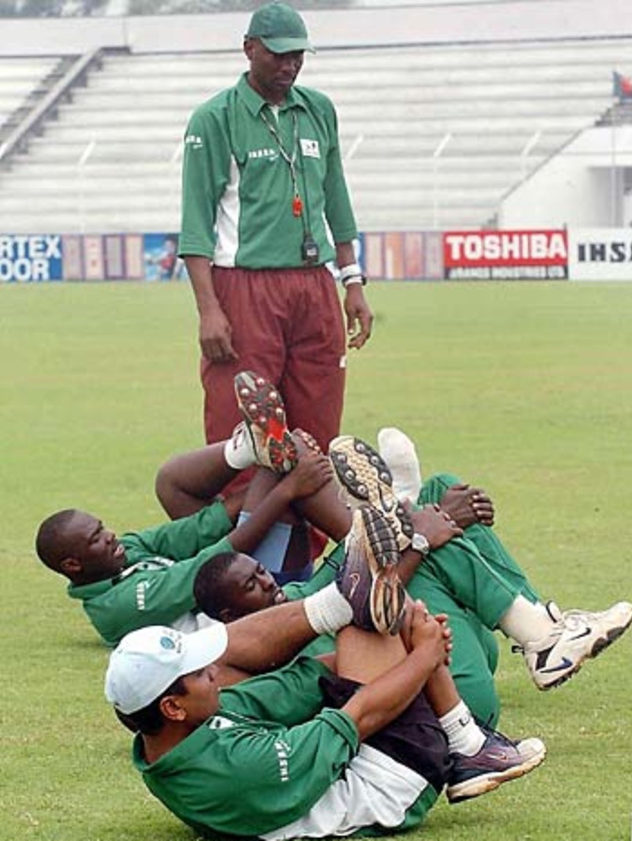 Roger Harper watches as Kenya's players loosen up, Bogra, March 16, 2006