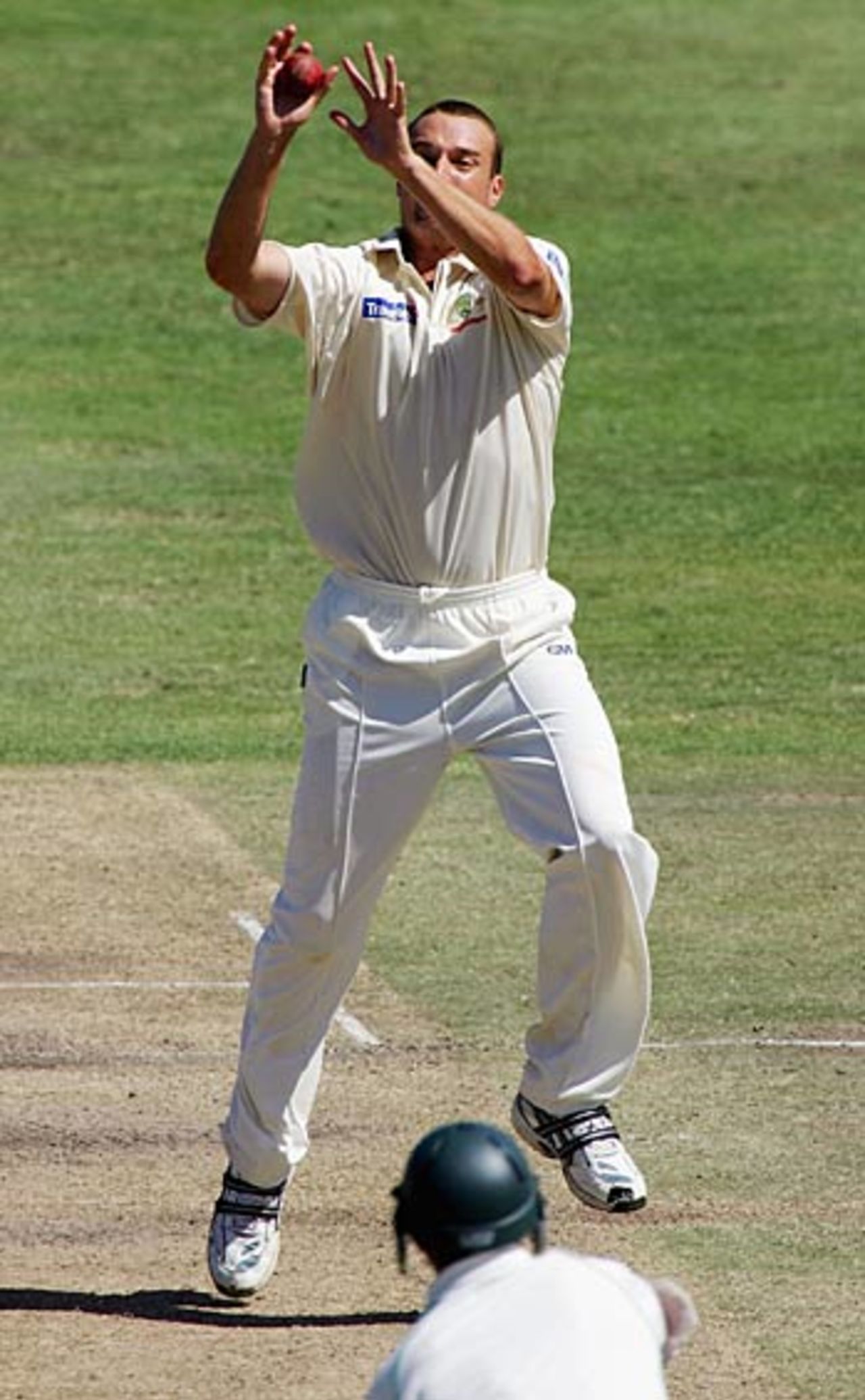 Stuart Clark clings onto a caught and bowled chance to remove Nicky Boje, his eighth wicket on debut, South Africa v Australia, 1st Test, Cape Town, March 18, 2006