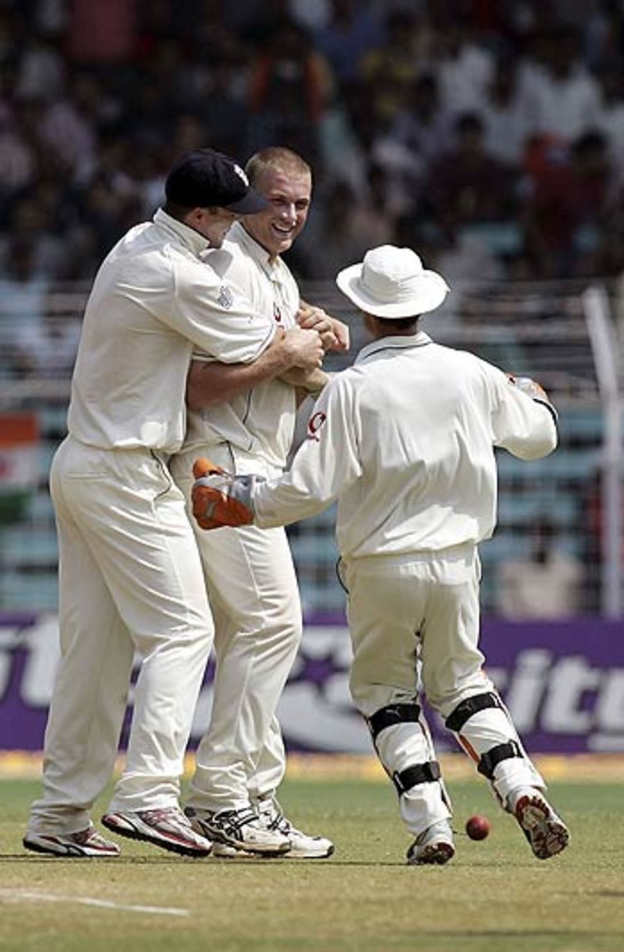 That man Freddie! England cricketers congratulate their captain after his early strike, India v England, 3rd Test, Mumbai, March 22, 2006