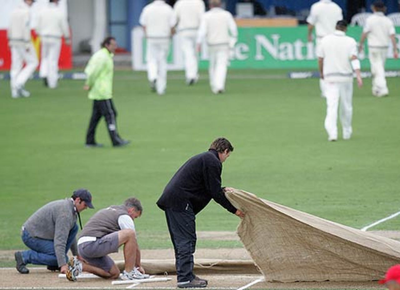 New Zealand leave the field as the covers go on after rain delayed play on the second day, New Zealand v West Indies, 3rd Test, Napier, 2nd day, March 26, 2006