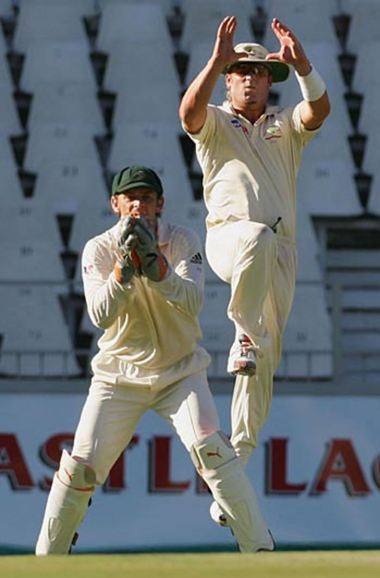 Adam Gilchrist catches Shaun Pollock as Shane Warne enjoys the moment from first slip, South Africa v Australia, 3rd Test, Johannesburg, April 2, 2006