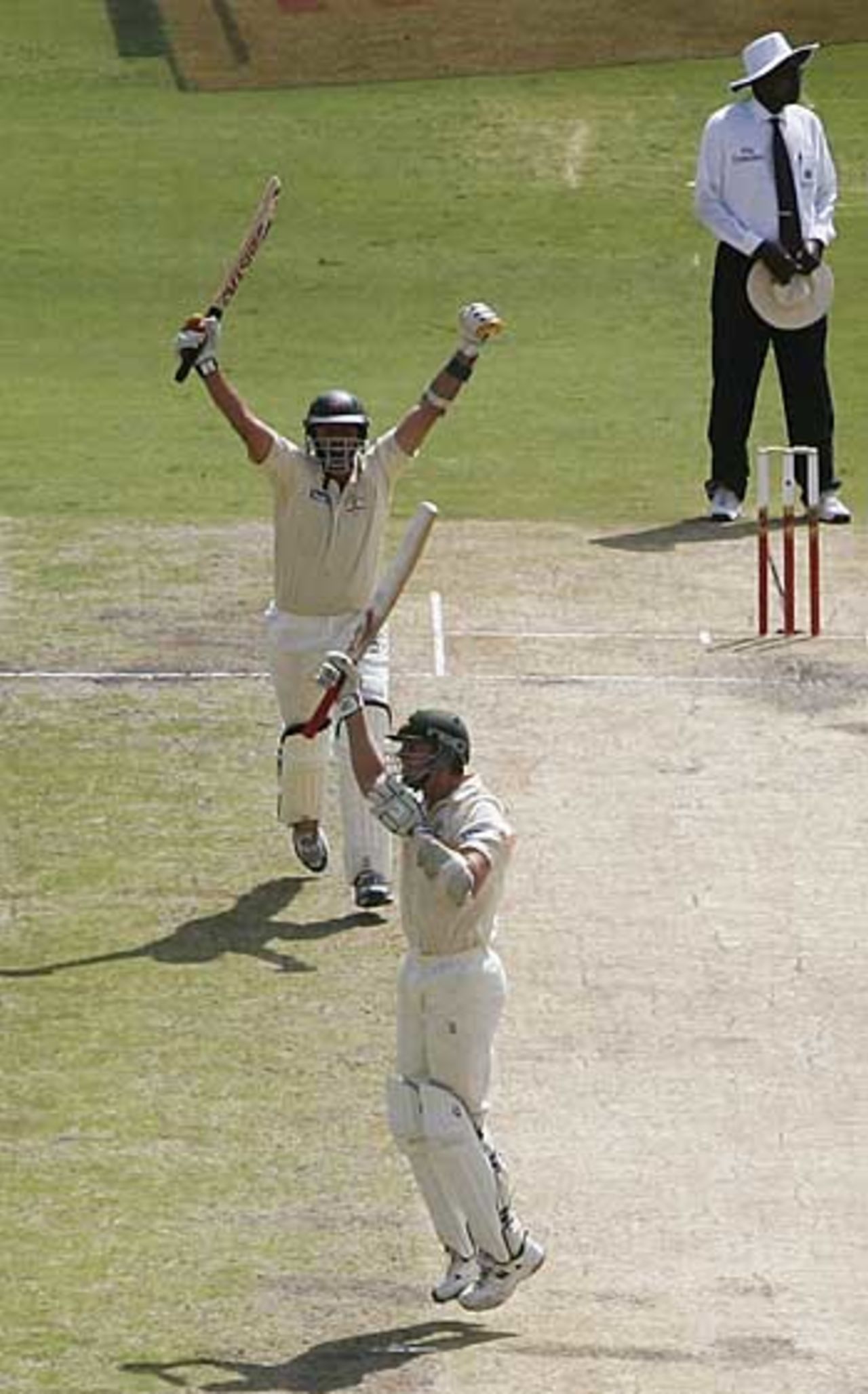 Arms aloft, Michael Kasprowicz and Brett Lee celebrate victory by two wickets, South Africa v Australia, 3rd Test, Johannesburg, 5th day, April 4, 2006