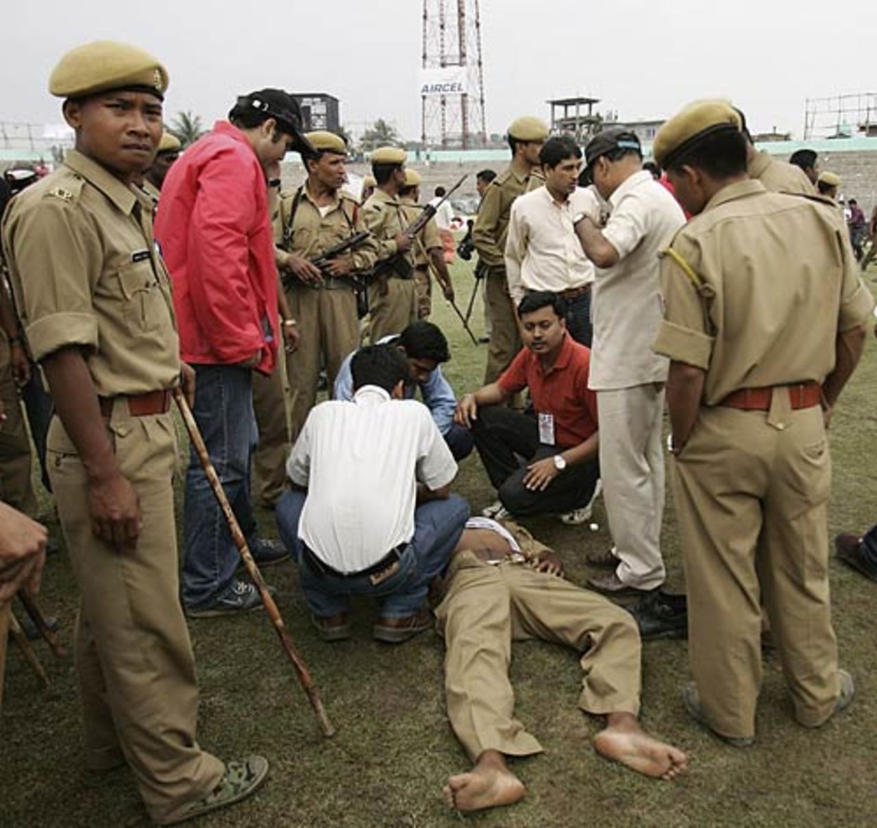 A policeman lies unconcious after being hit by a rock as violence broke out after play was abandoned , India v England, 5th ODI, Guwahati,  April 9, 2006