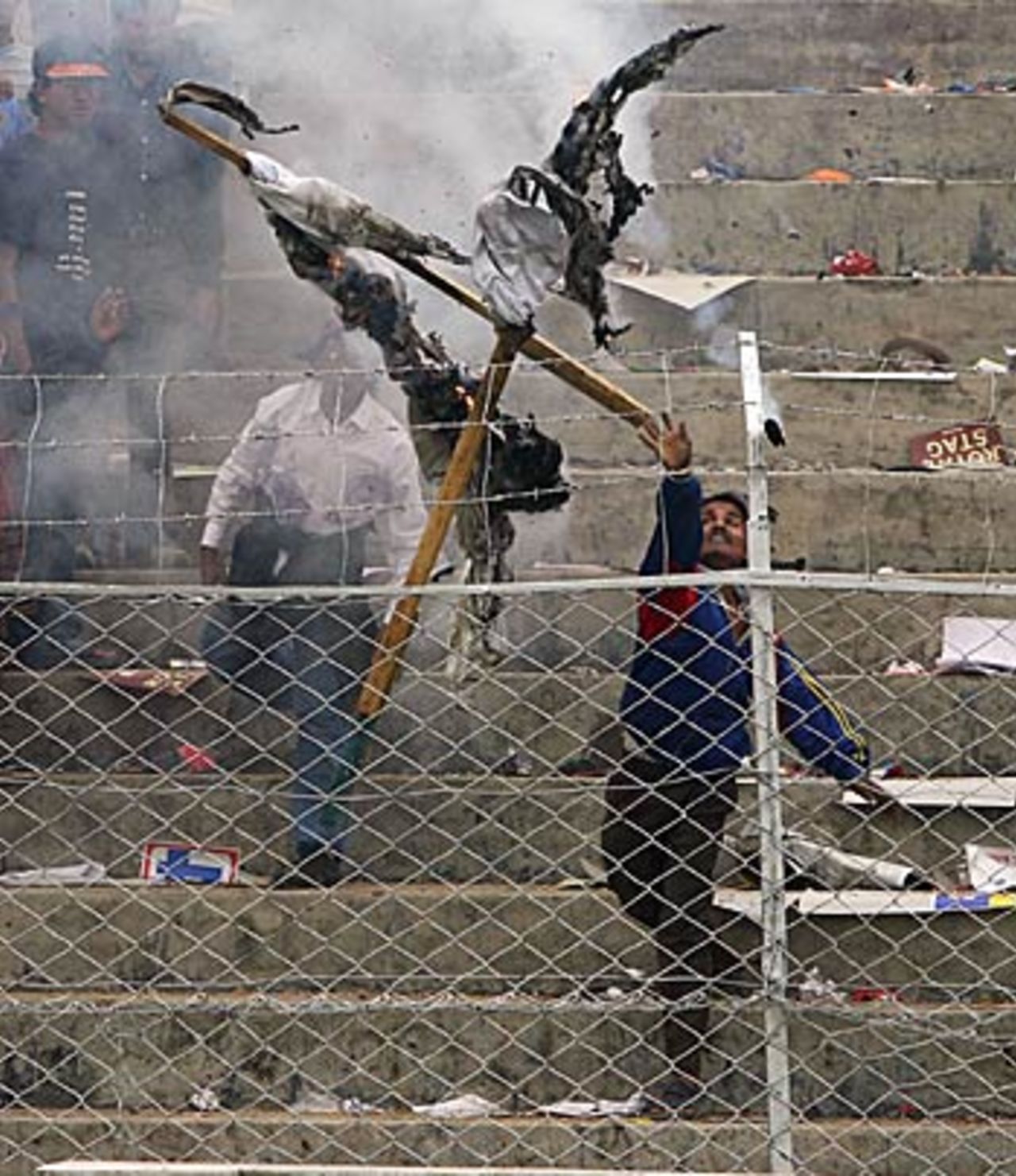 Irate fan throws burning material towards the playing surface, India v England, 5th ODI, Guwahati,  April 9, 2006