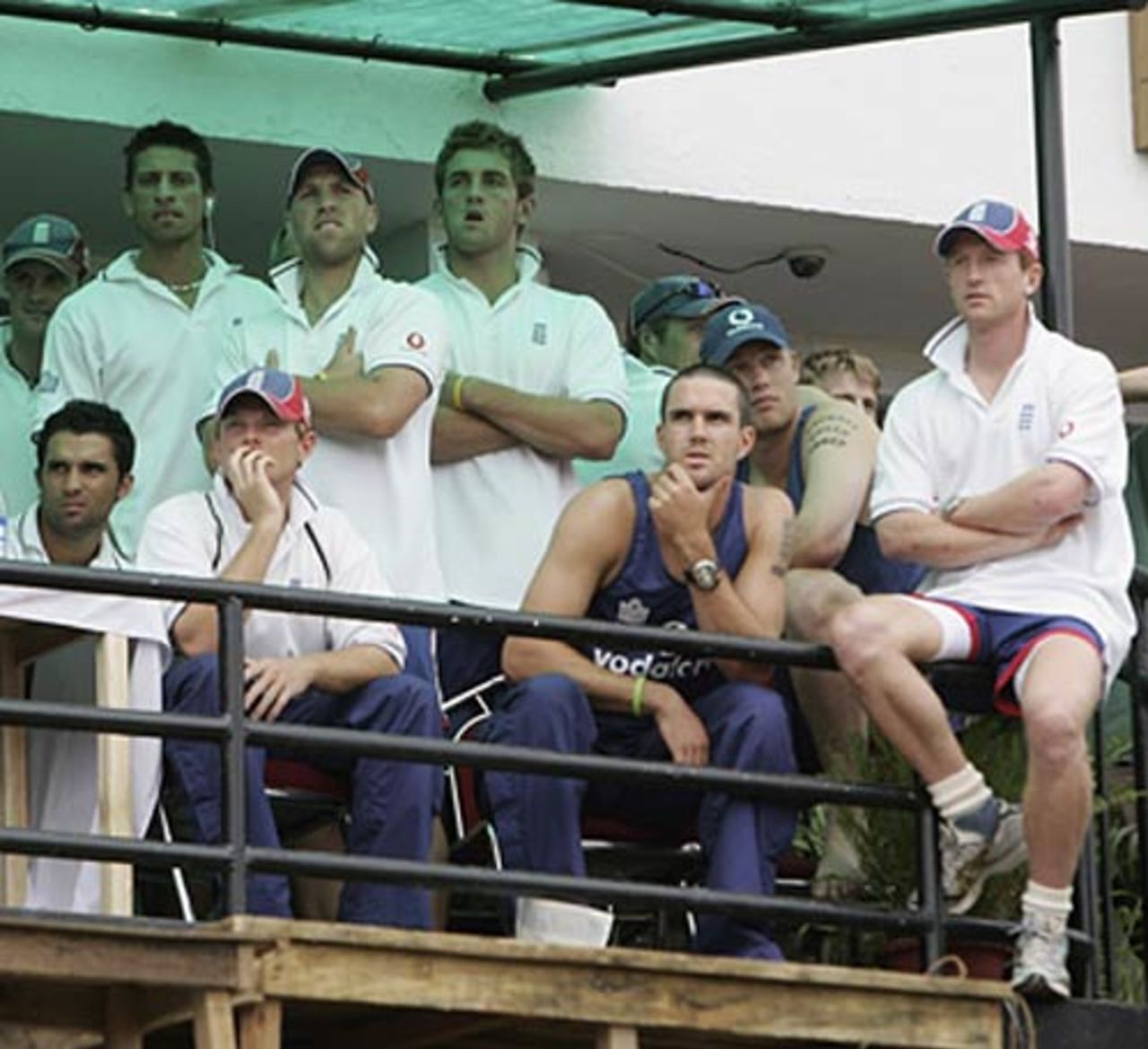 England team look on as fans throw bottles and stones and light fires as violence broke out after match was abandoned  , India v England, 5th ODI, Guwahati,  April 9, 2006
