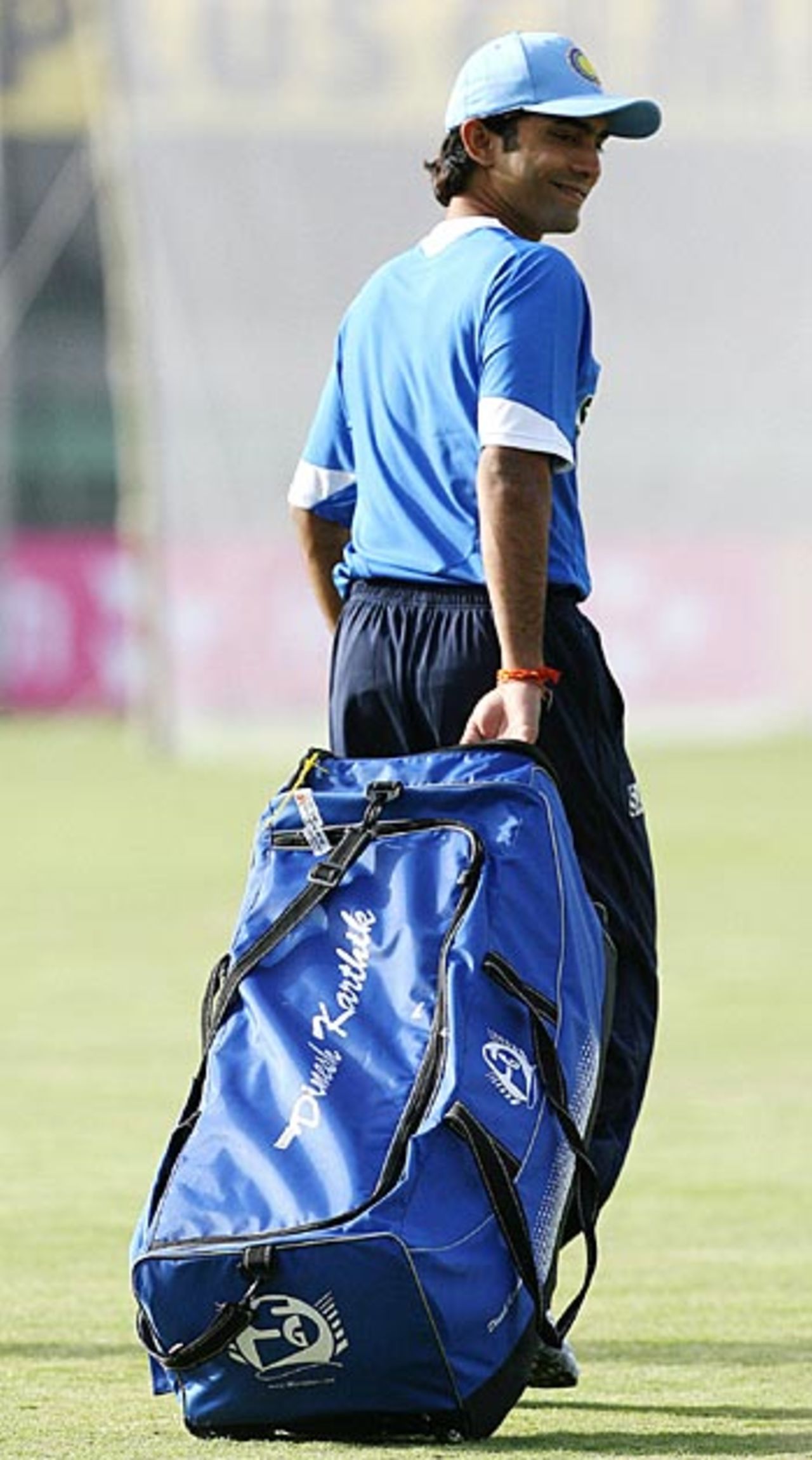 Dinesh Karthik arrives with his kit for net practice at Usha Raje Cricket ground in Indore, April 13, 2006
