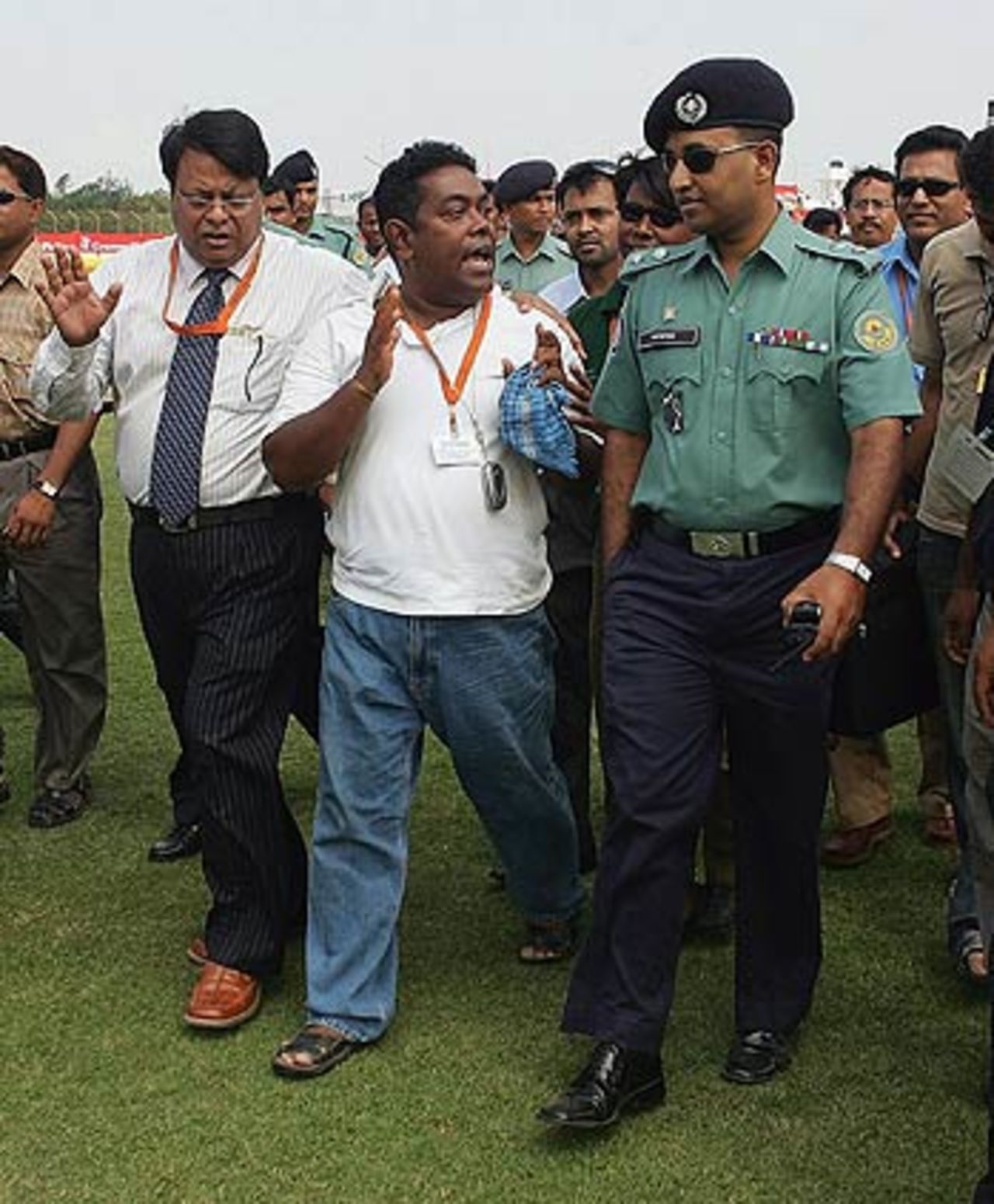 Photographer Shamsul Haque Tanku speaks with police during an onfield protest after he was beaten on entry to the ground , Bangladesh v Australia, 2nd Test, Chittagong, 1st day, April 16, 2006