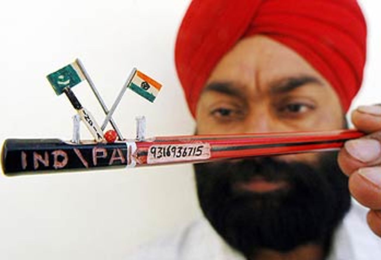 Indian artist and Guinness Book of World Record holder Jaspal Singh Kalsi displays a miniature handmade wooden pitch featuring Indian and Pakistani flags, Amritsar, April 18, 2006