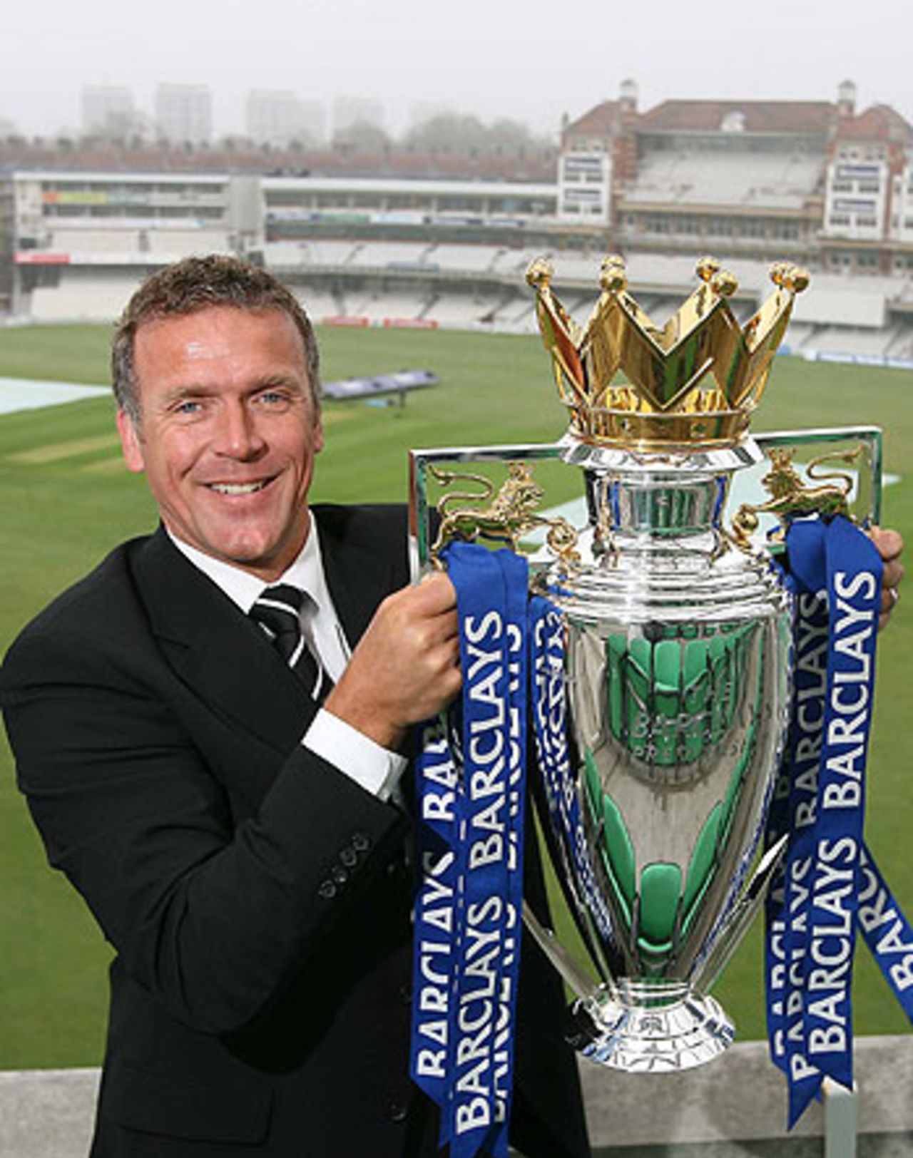 Chelsea fan Alec Stewart poses with the Premiership trophy ...
