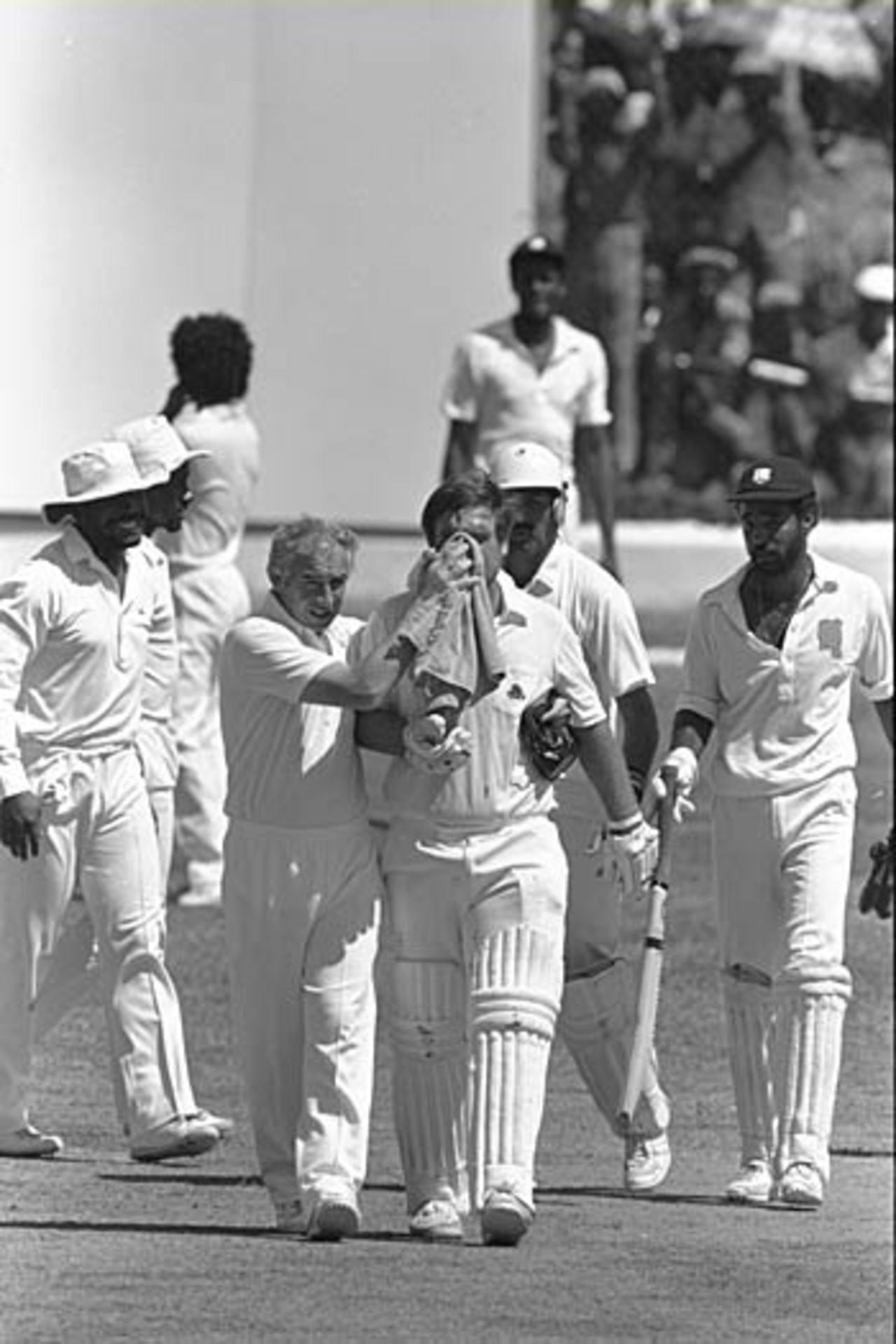 Mike Gatting leaves the field with a broken nose after being hit  by a vicious bouncer from Malcolm Marshall