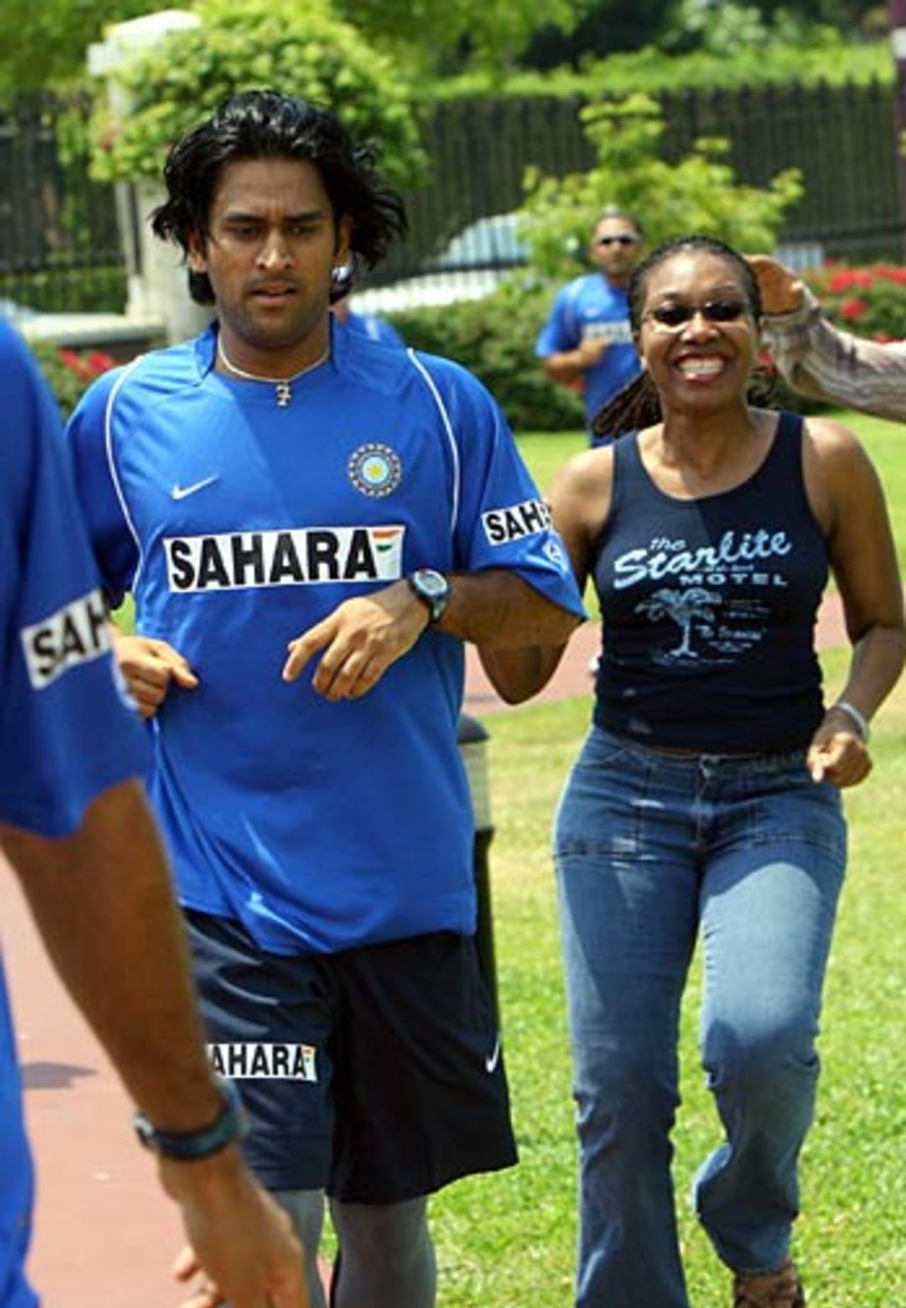 Mahendra Singh Dhoni jogs along with a fan as the Indians train at the start of their tour to West Indies, Kingston, May 13, 2006