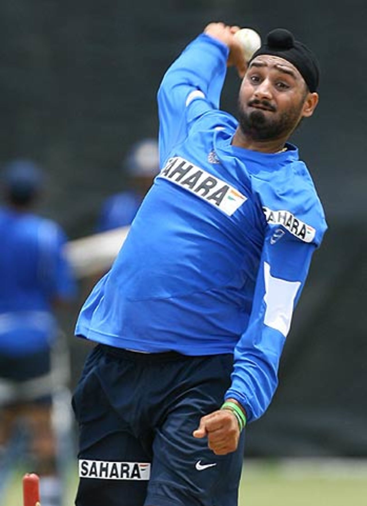 Harbhajan Singh works on his offbreaks during the Indian team's practice session in Spanish Town, May 14, 2006