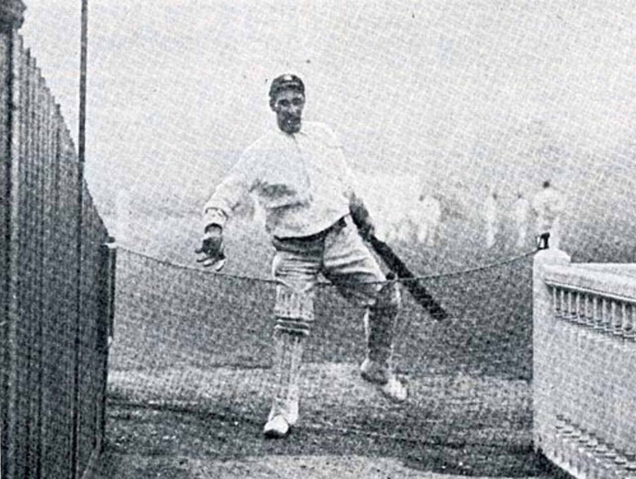 Albert Trott clambers over experimental boundary netting at Lord's, 1900