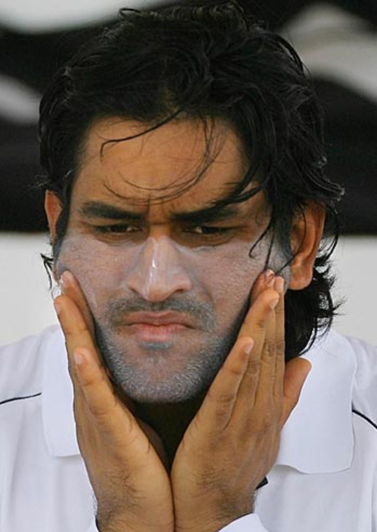 Mahendra Singh Dhoni applies suncream before the start of the warm-up match against Antigua and Barbuda, Police Grounds, Antigua, May 30, 2006