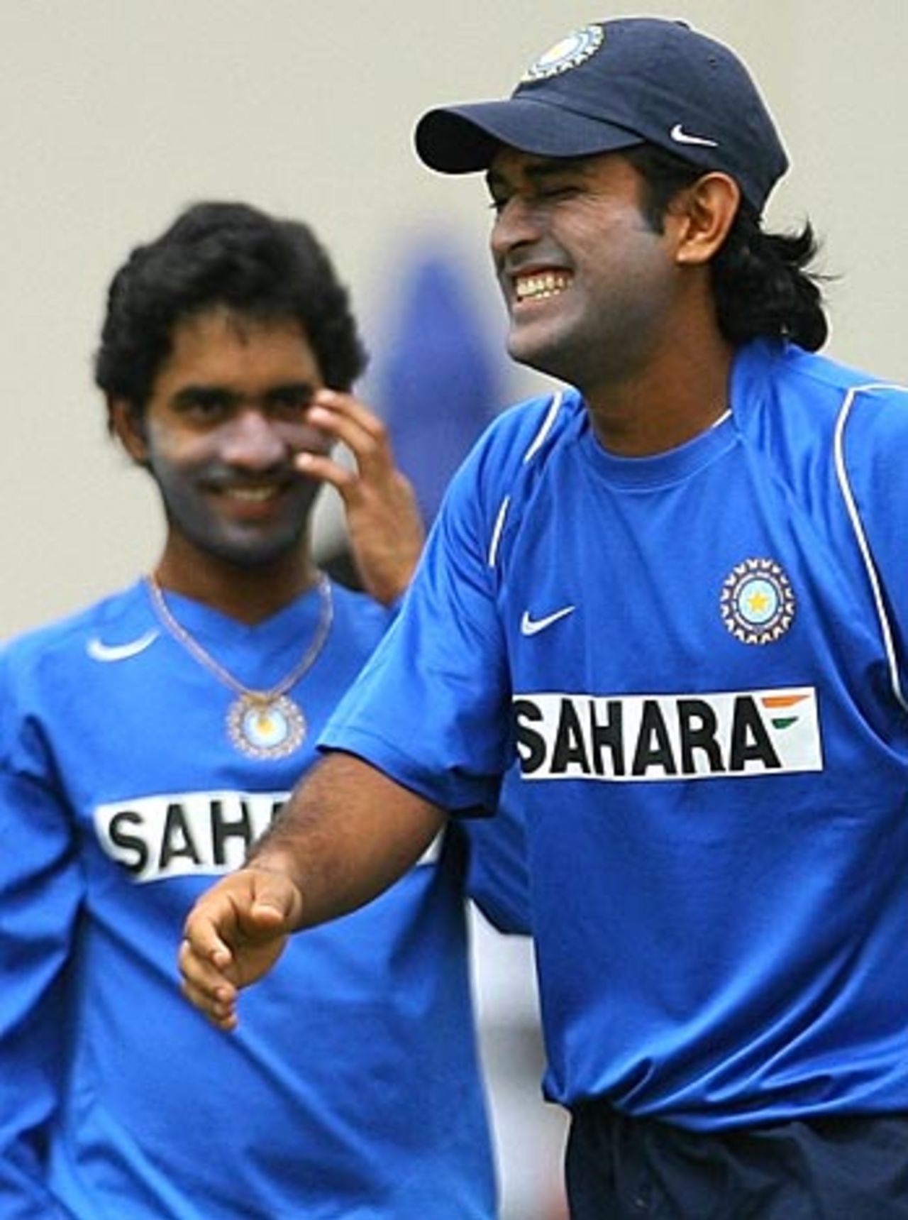 Dinesh Karthik watches a relaxed team-mate Mahender Singh Dhoni , St Lucia, June 9, 2006