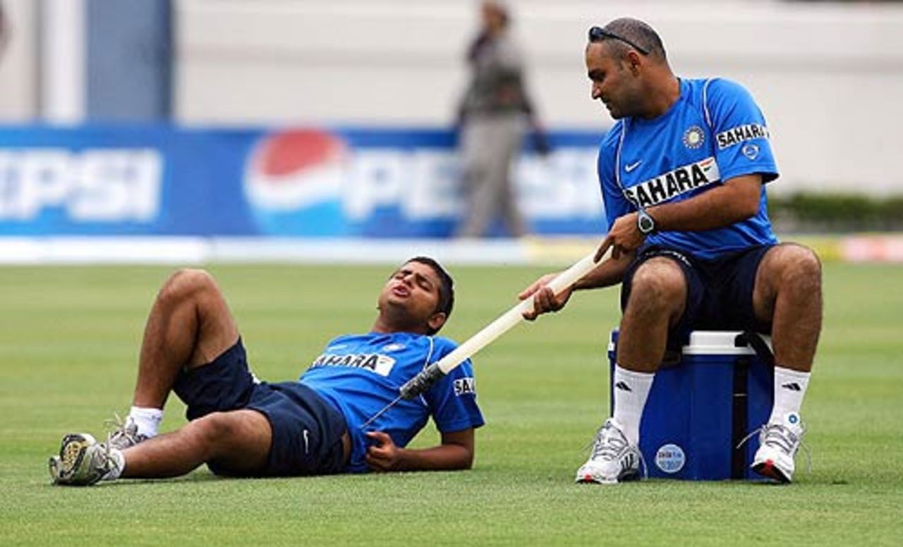 Virender Sehwag tries to break Suresh Raina's slumber with a stump before the start of the fourth day, West Indies v India, 2nd Test, St Lucia, 4th day, June 13, 2006