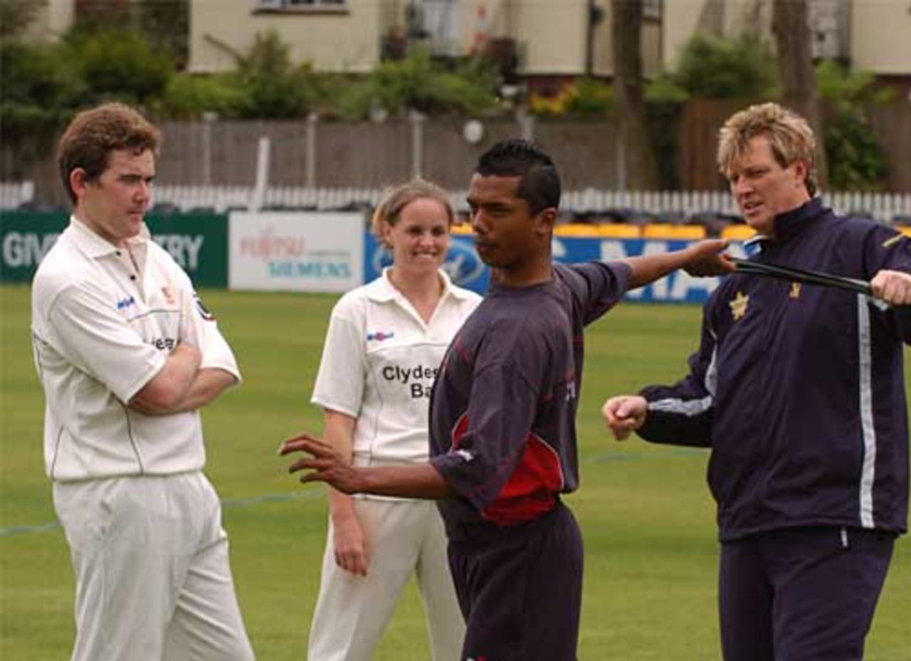 Jahid Ahmed helps out Essex fast-bowling coach Ian Pont with a bowling demonstration