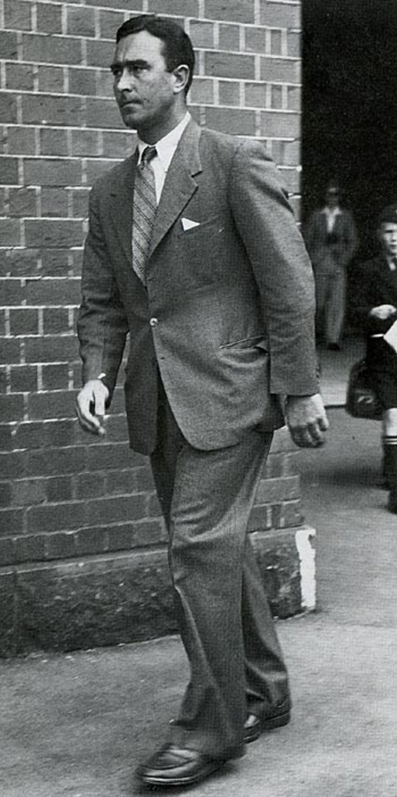 Denis Compton walks away from the SCG after being ruled out of the Test because of his long-standing knee injury, February 1951