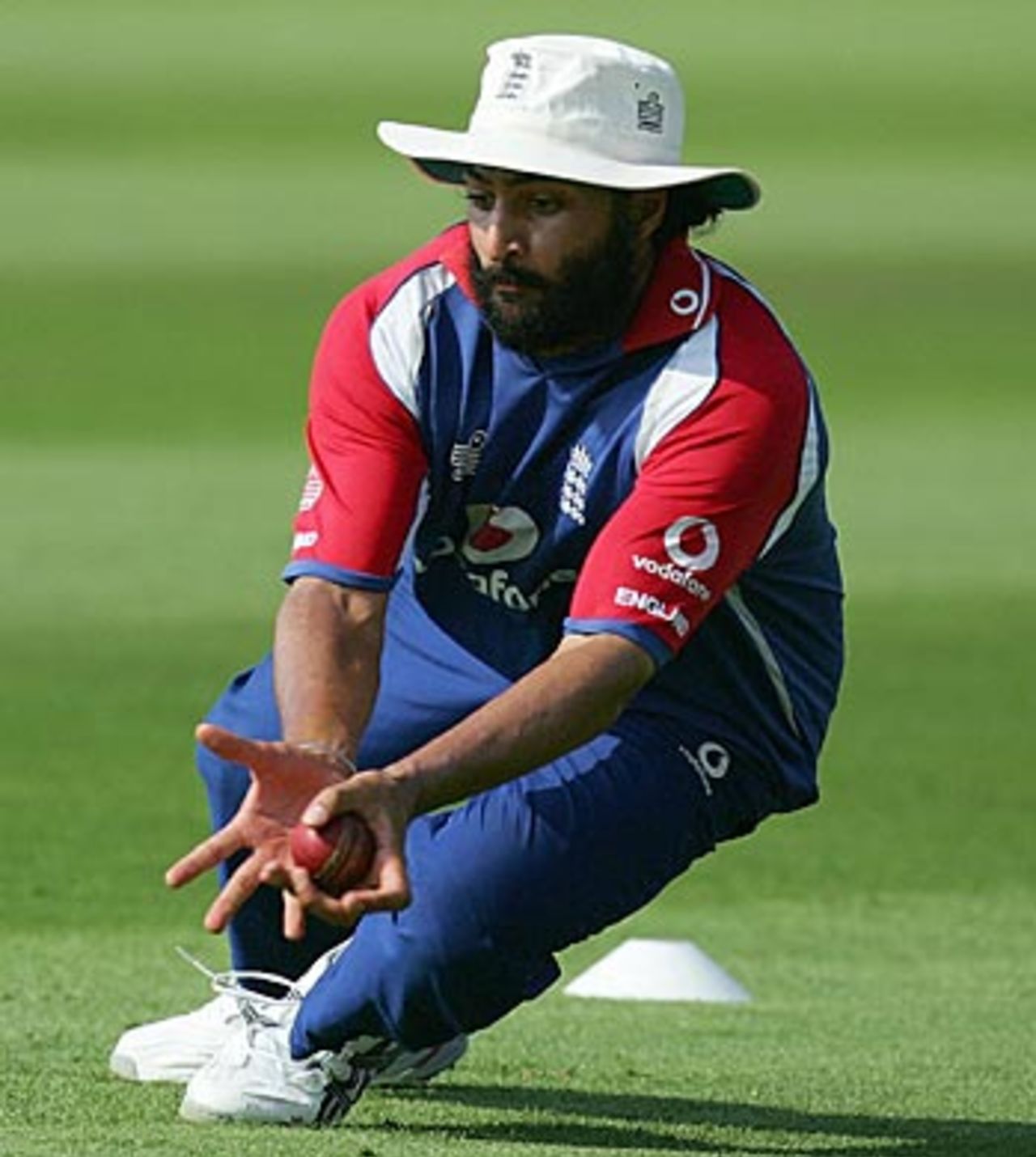 Monty Panesar stoops to field a ball during a training session ahead of the second Test against Pakistan, Old Trafford, July 26, 2006