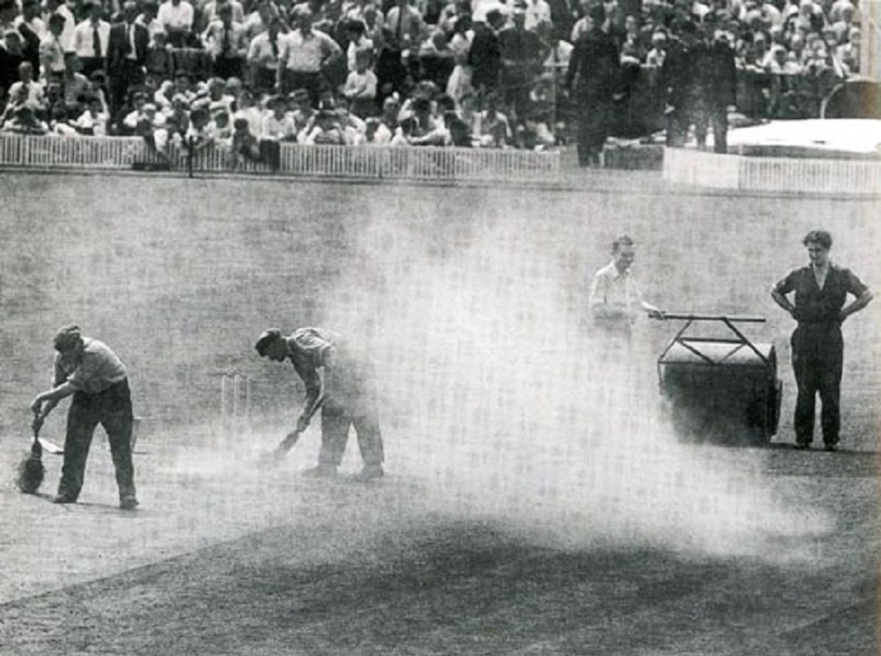 Clouds of dust as groundstaff sweep the pitch before Australia's first innings, England v Australia, Manchester, July 27, 1956