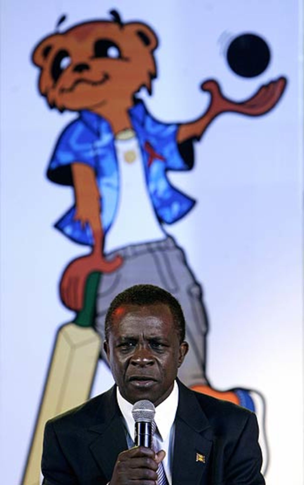 Mello, the 2007 World Cup's mascot, is in the background as Keith Mitchell, the prime minister of Grenada, addresses the media at the launch of the World Cup logo, mascot and the tournament schedule, New Delhi, July 27, 2006