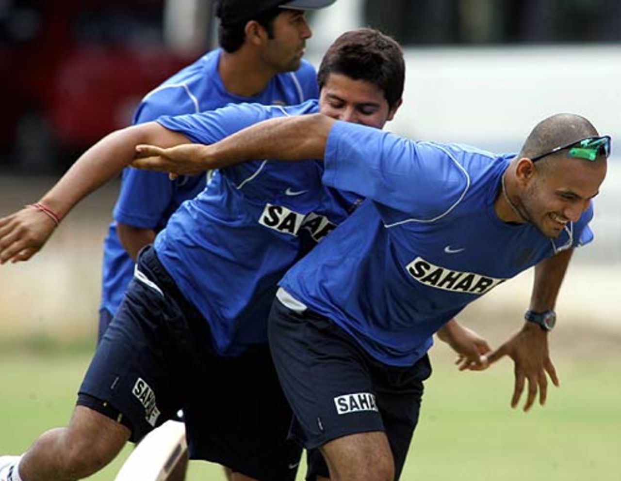 Irfan Pathan shares a light moment with Suresh Raina during training, National Cricket Academy, Bangalore, August 1, 2006