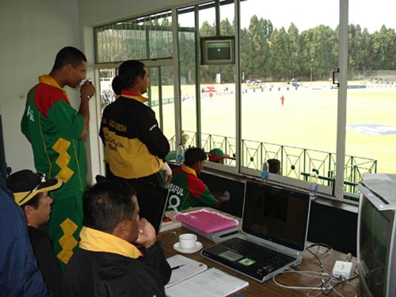 Bangladesh's players watch the match from the comfort of their dressing room, Zimbabwe v Bangladesh, 3rd ODI, Harare, August 2, 2006
