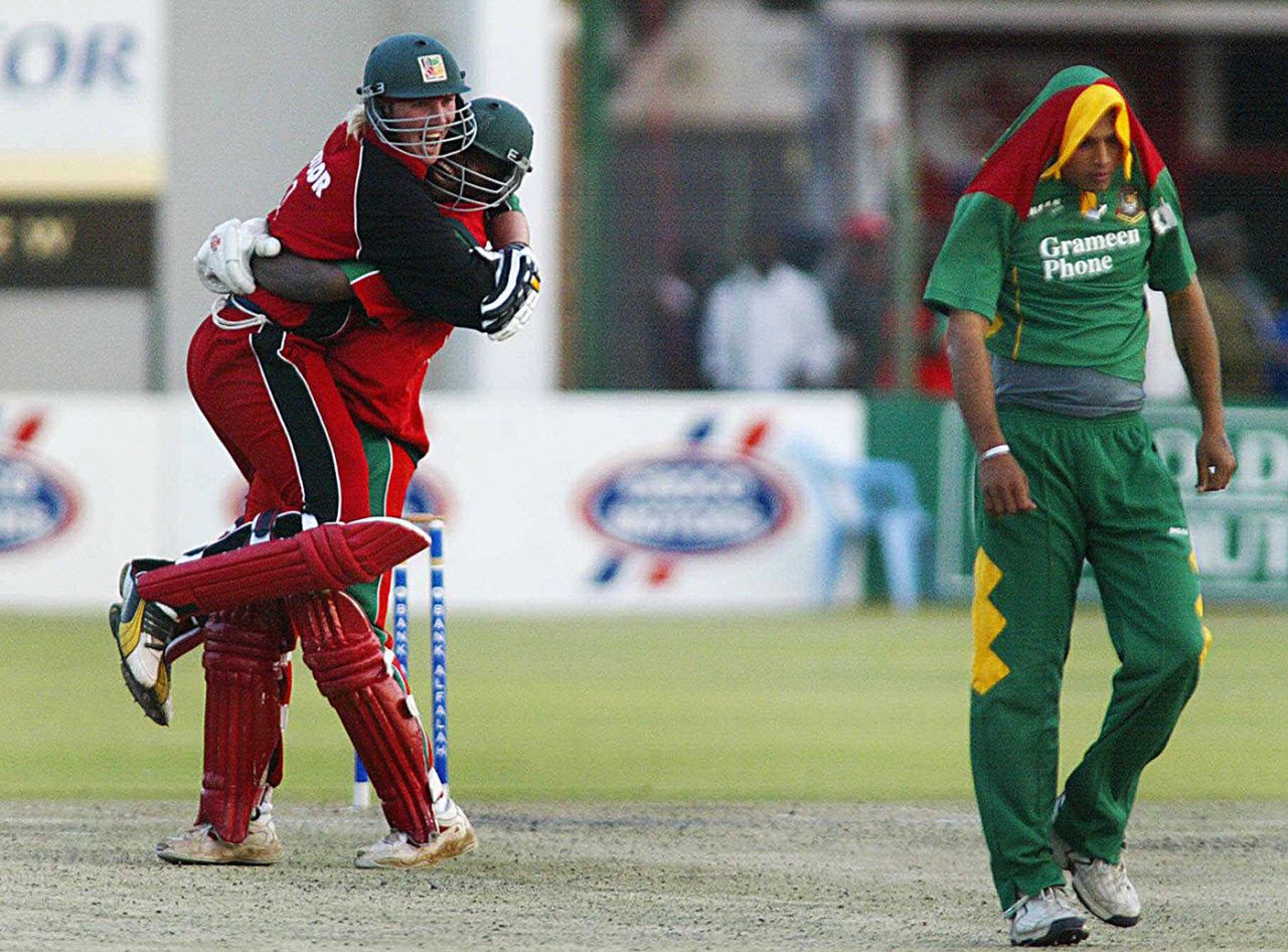 Brendan Taylor  and Blessing Mahwire celebrate as a dejected Mashrafe Mortaza trudges away, Zimbabwe v Bangladesh, 3rd ODI, Harare, August 2, 2006
