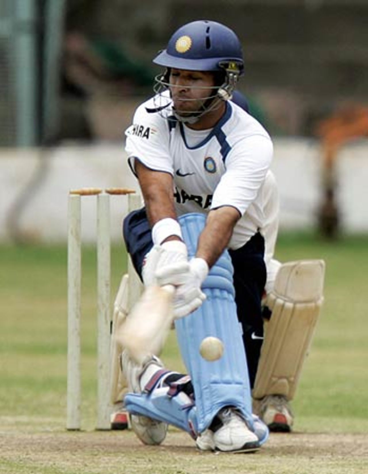 Yuvraj Singh sweeps with his eyes shut during a practice match , National Cricket Academy, Bangalore, August 8, 2006
