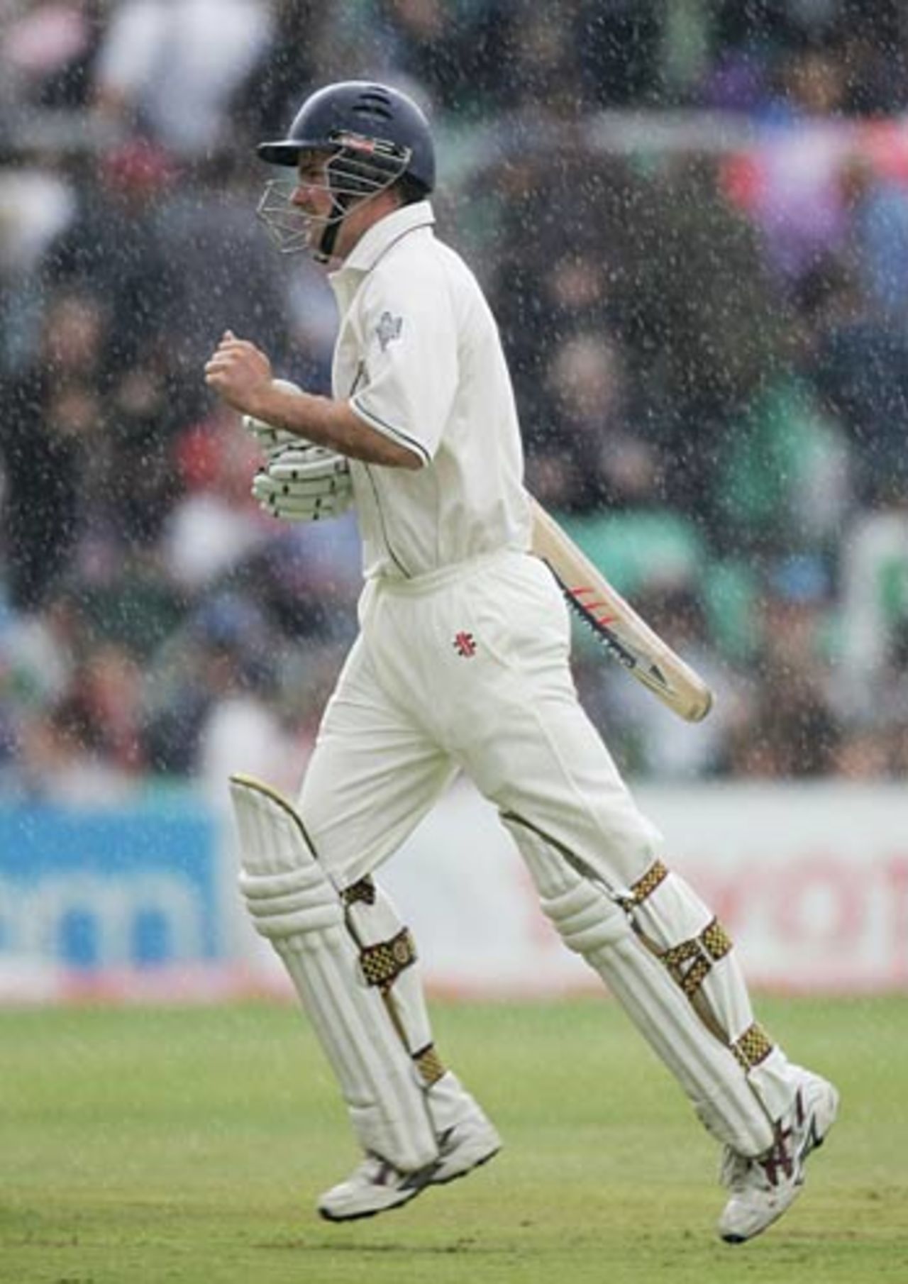 Andrew Strauss runs for cover as the rain falls on the first morning, England v Pakistan, 4th Test, The Oval, August 17, 2006