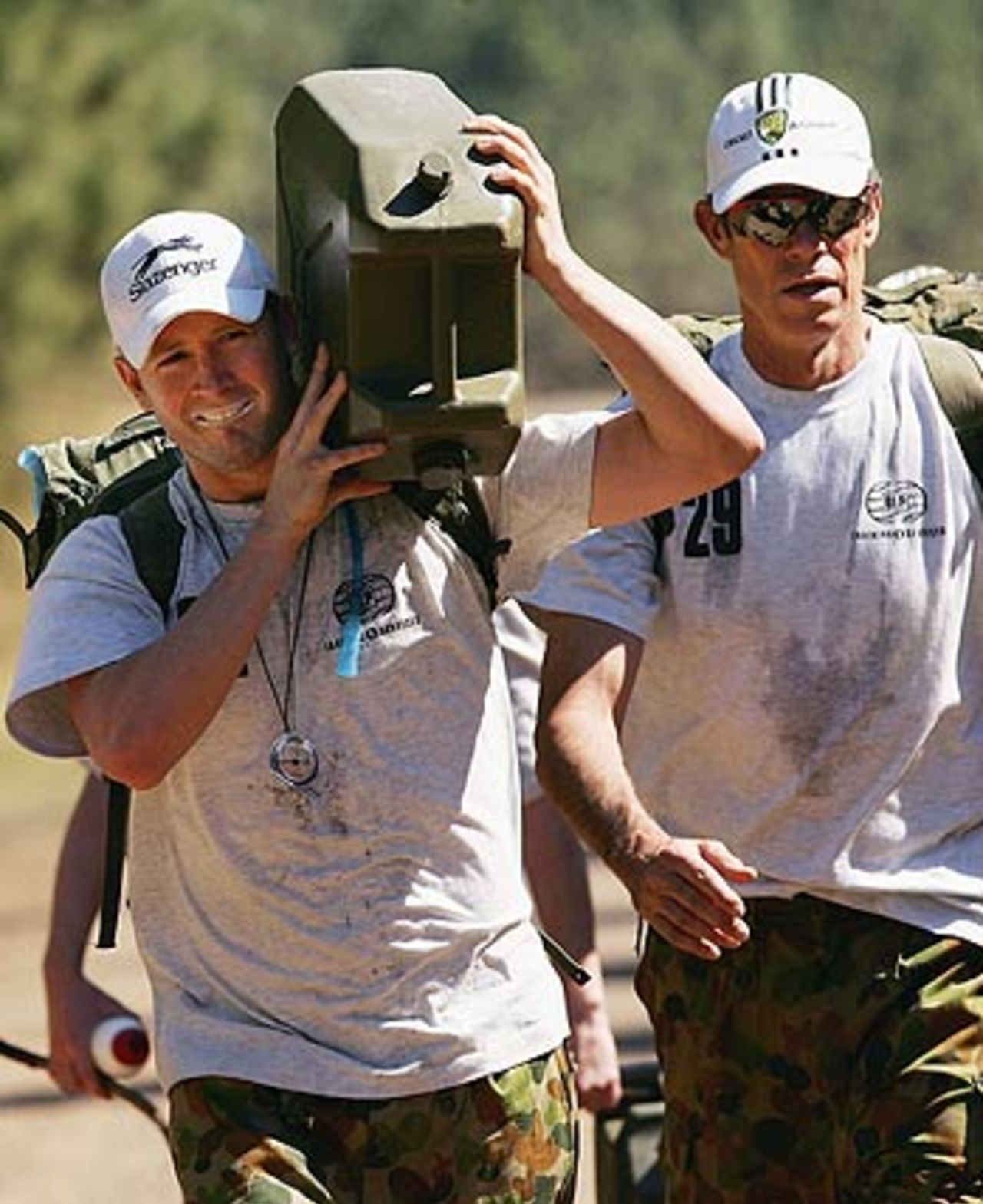 Michael Clarke carries the jerry can on his shoulder during an outback boot camp in the Beerwah State Forest, Brisbane, August 23, 2006