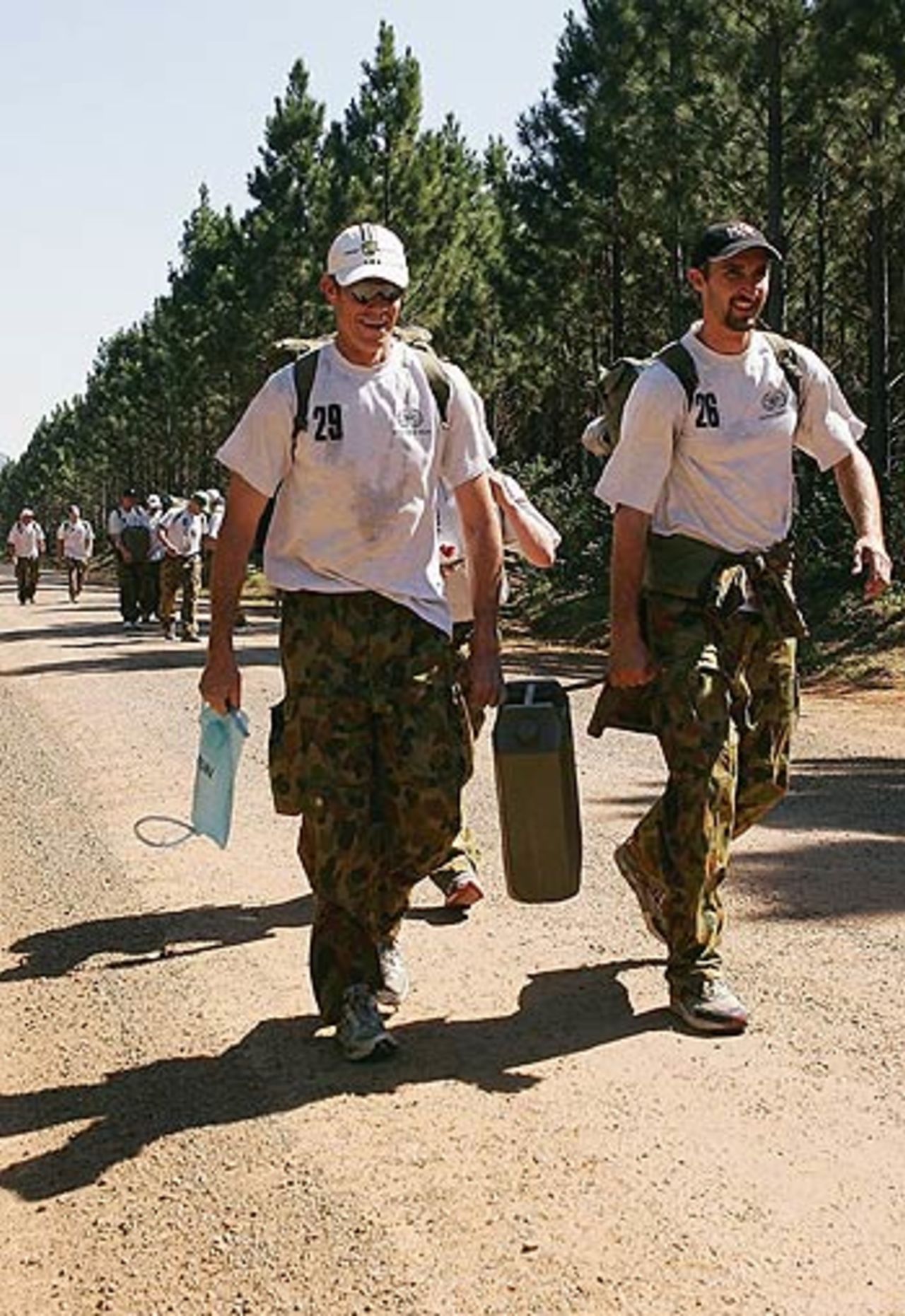 John Buchanan and Jason Gillespie share the burden during an outback boot camp in the Beerwah State Forest, Brisbane, August 23, 2006