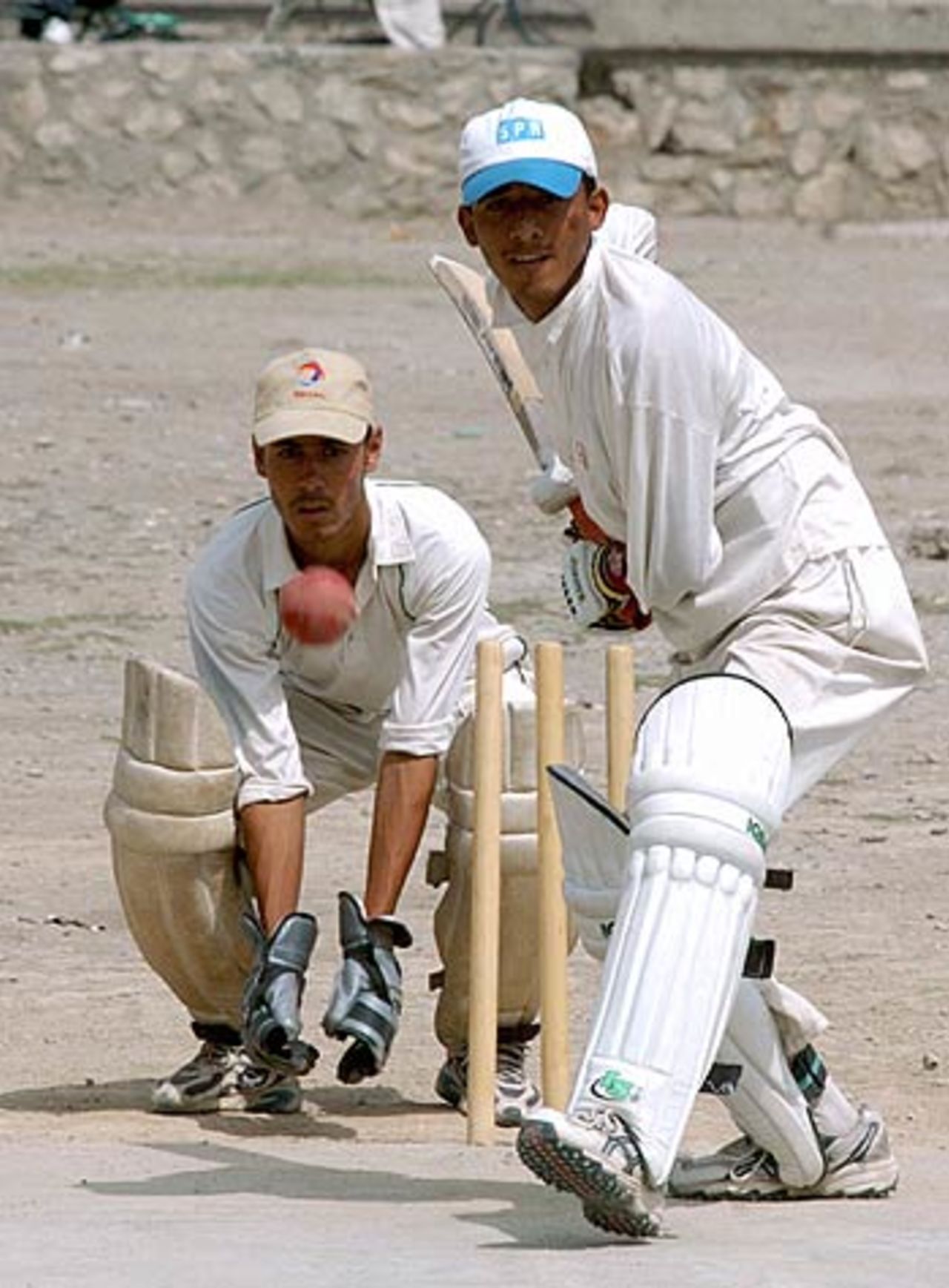 Afghan cricketers play outside the national stadium, Kabul, August 23, 2006