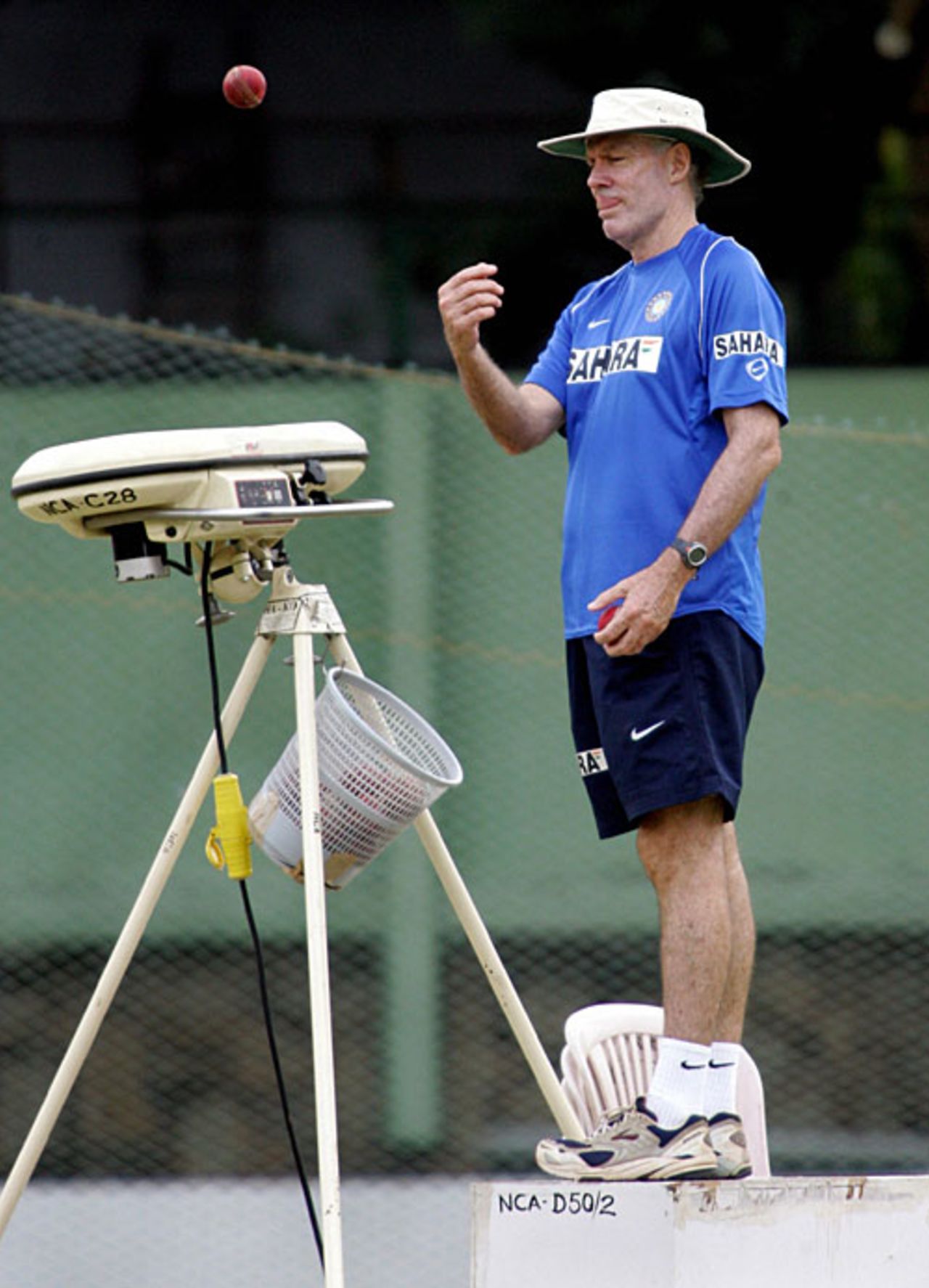Greg Chappell loads the bowling machine at  India's training camp in Bangalore, August 31, 2006