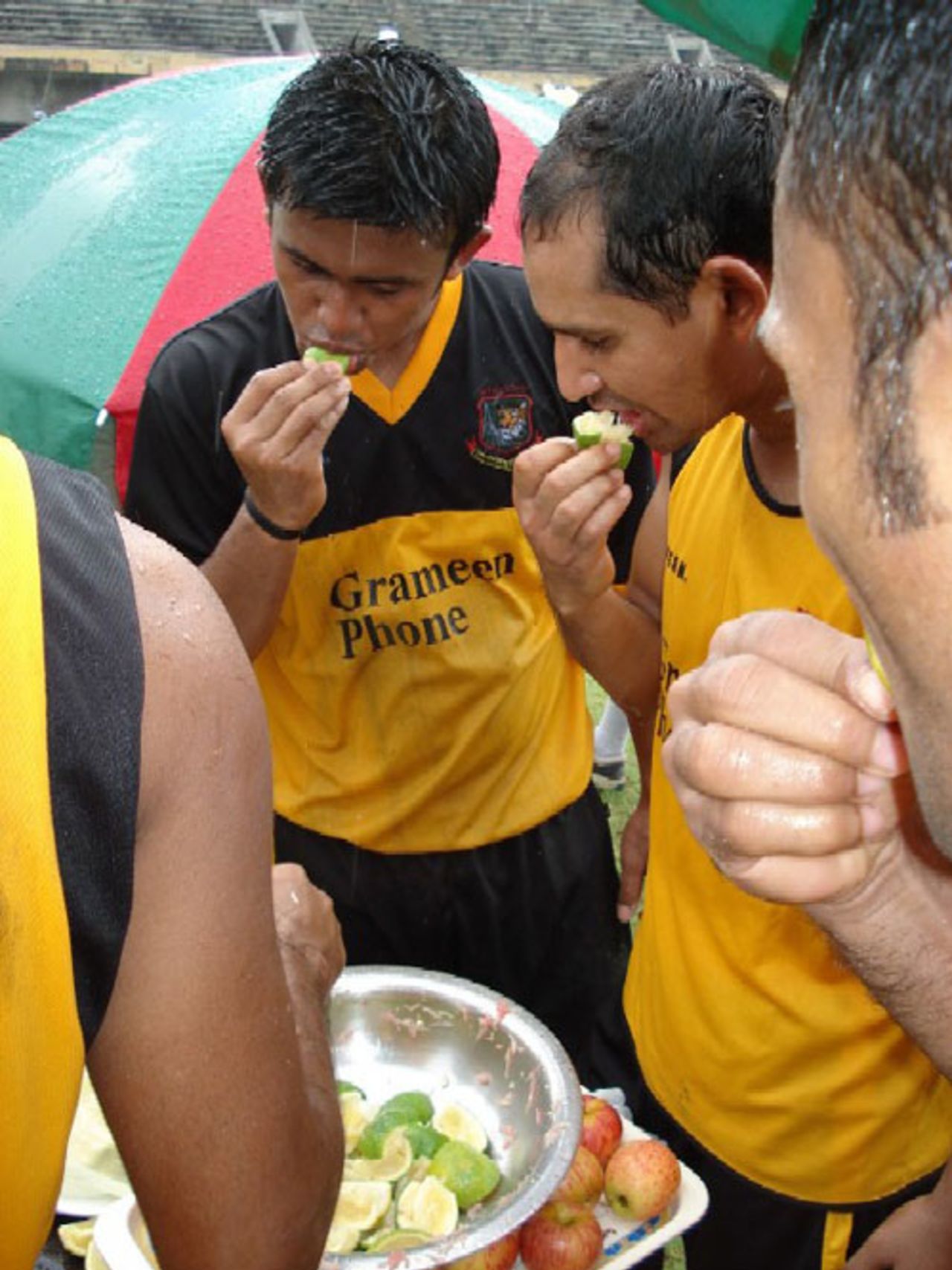 Bangladesh captain Habibul Bashar and his deputy Shahriar Nafees Ahmed enjoy a fruit break in the rain at Mirpur, August 31, 2006