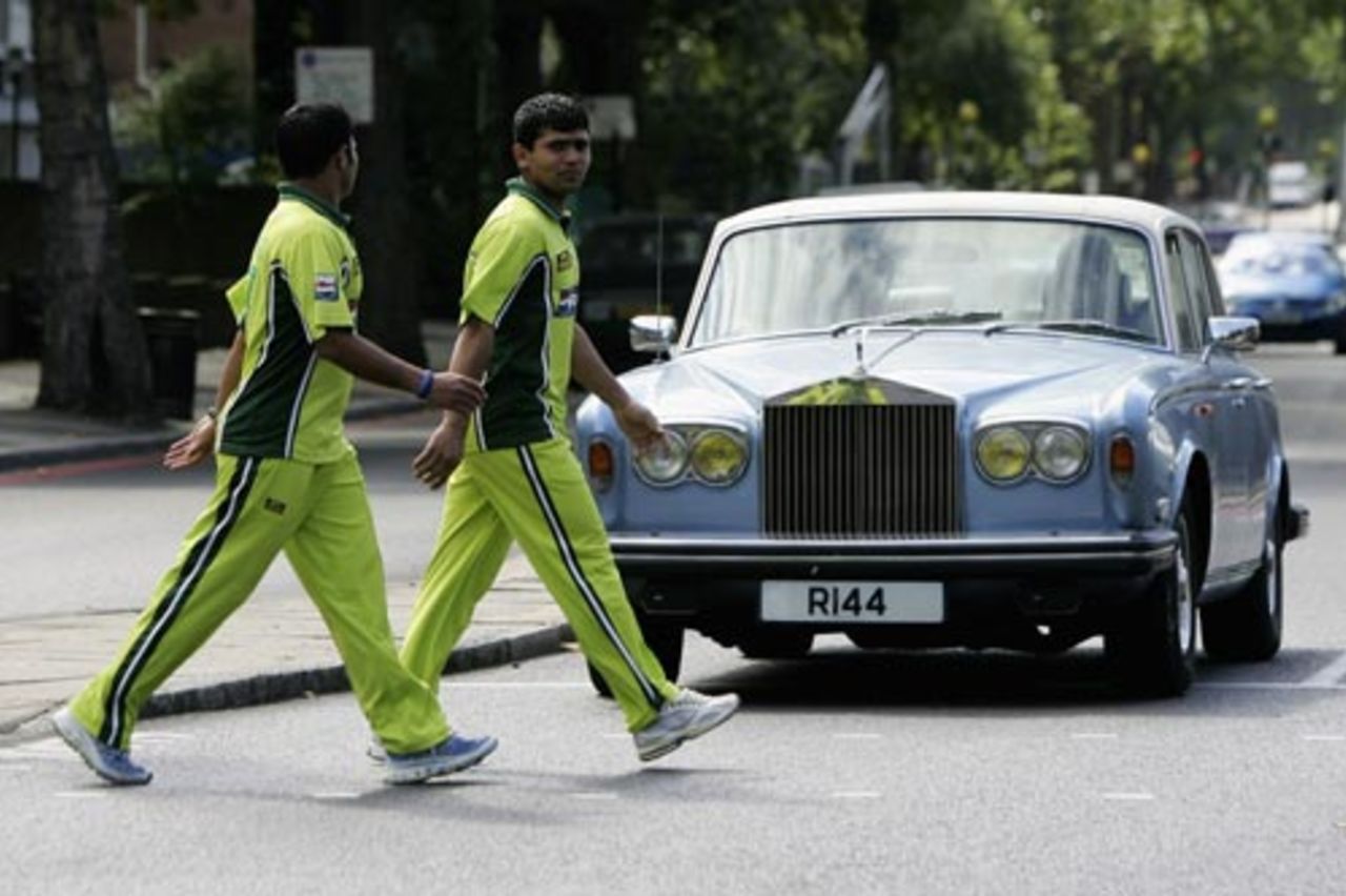 Kamran Akmal and Imran Farhat cross the road on their return from Friday prayer at Regent's Park mosque, London, September 1, 2006