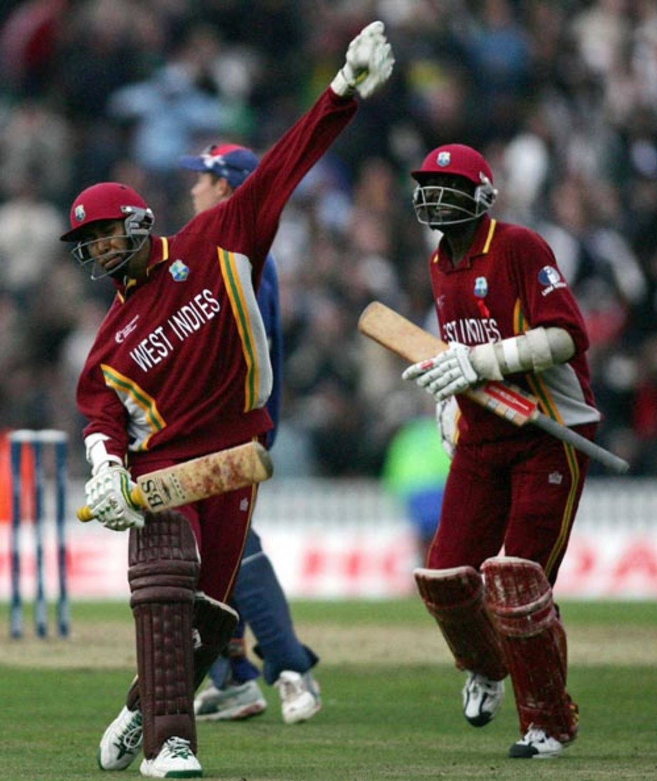 Ian Bradshaw and Courtney Browne celebrate a thrilling one-wicket win in the finals of the Champions Trophy, The Oval, September 25, 2004