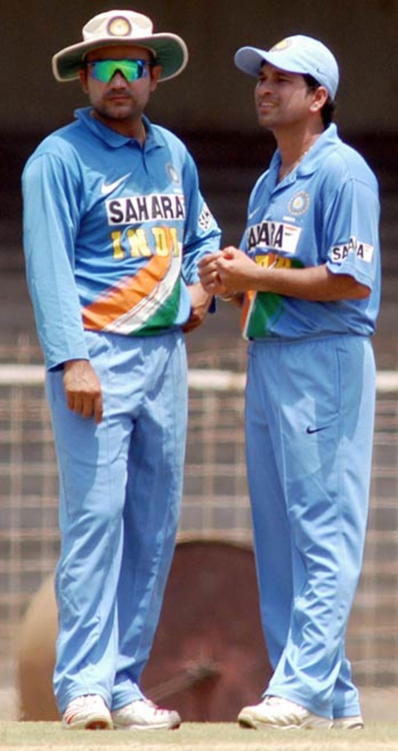 Sachin Tendulkar (R) and Virender Sehwag speak as they take part in a practice match at The M.A.Chidambaram Stadium in Chennai, September 8, 2006.