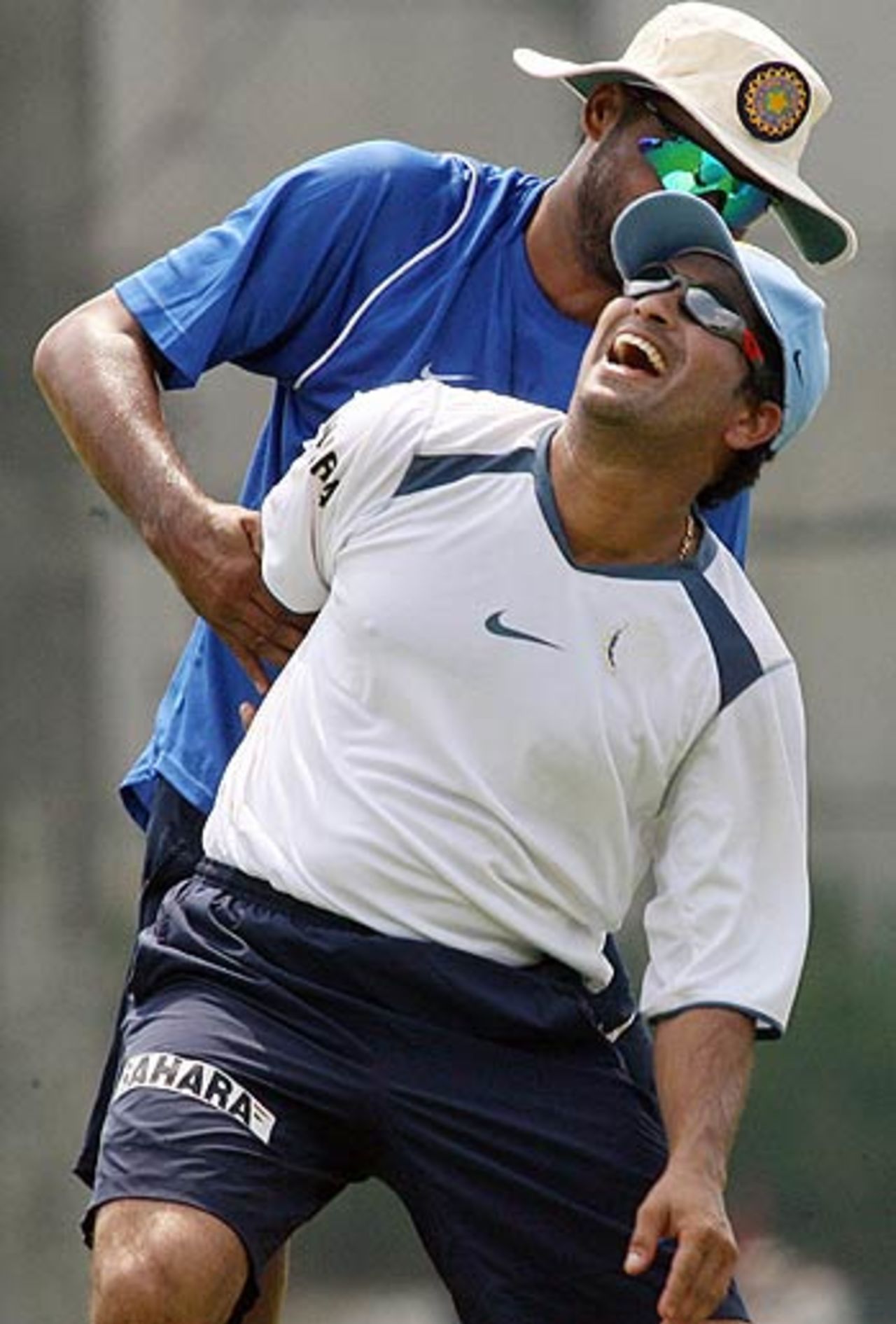 Harbhajan Singh helps Sachin Tendulkar with his stretching, Kuala Lumpur, September 12, 2006