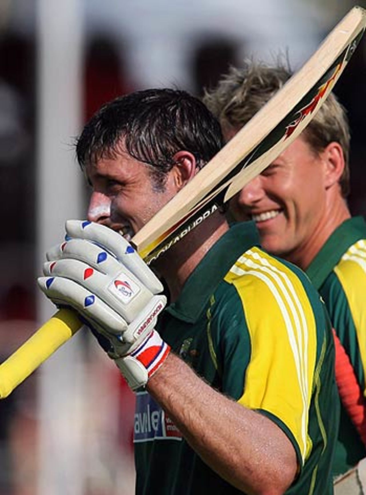 Michael Hussey is all smiles as he walks back after his unbeaten ton as Brett Lee looks on, Australia v West Indies, DLF Cup, 4th match, September 18, 2006